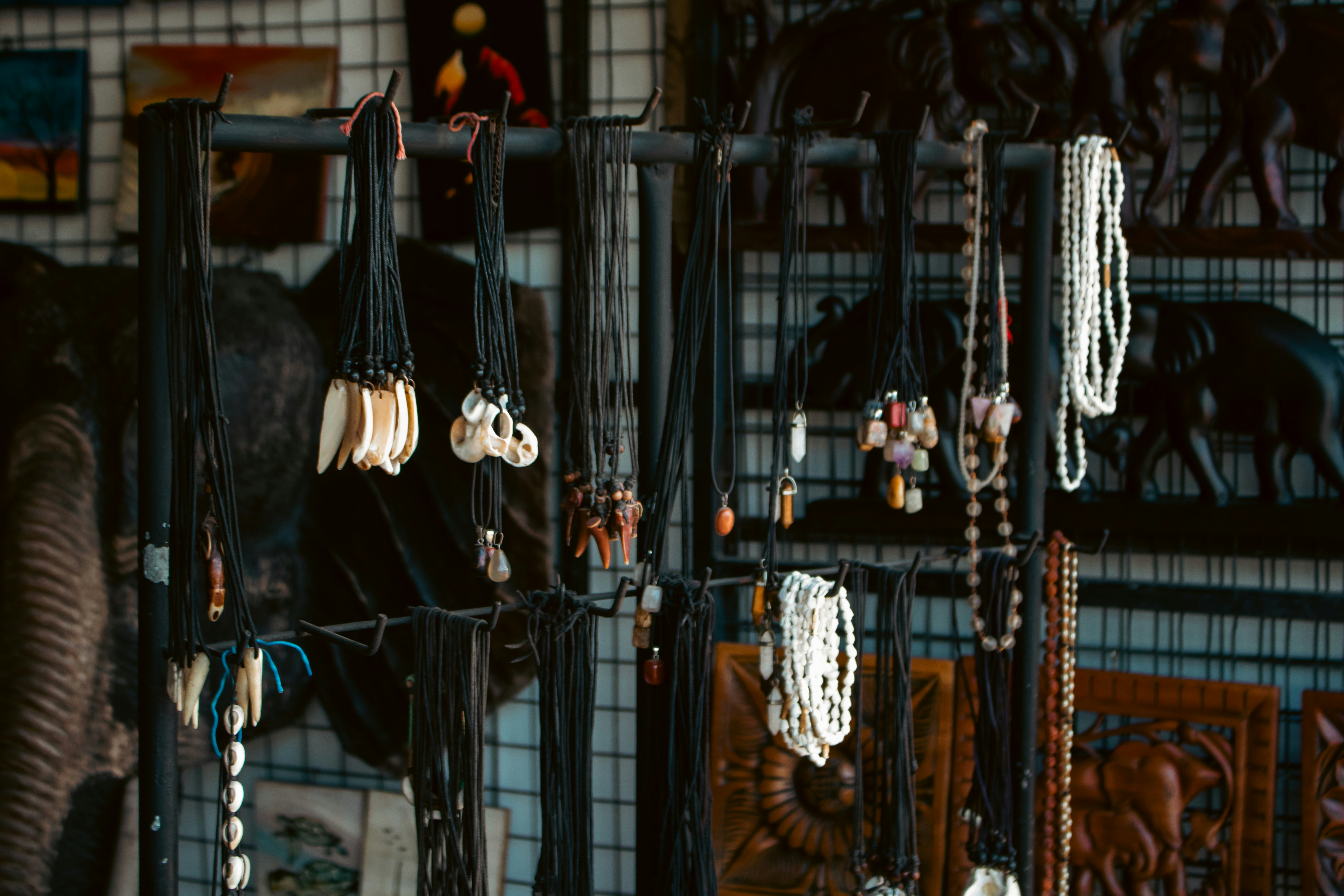 Necklaces with beads and animal carvings displayed