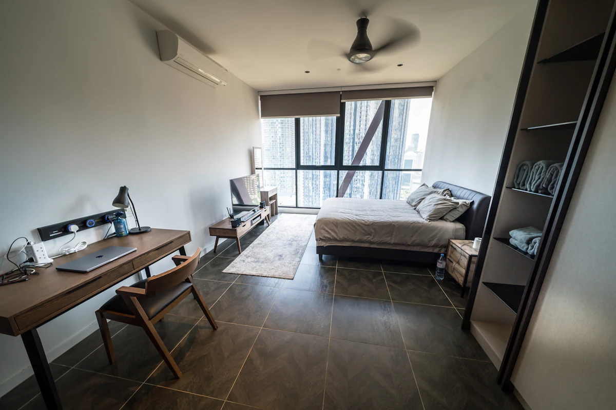 Private room with bed, desk and a city view