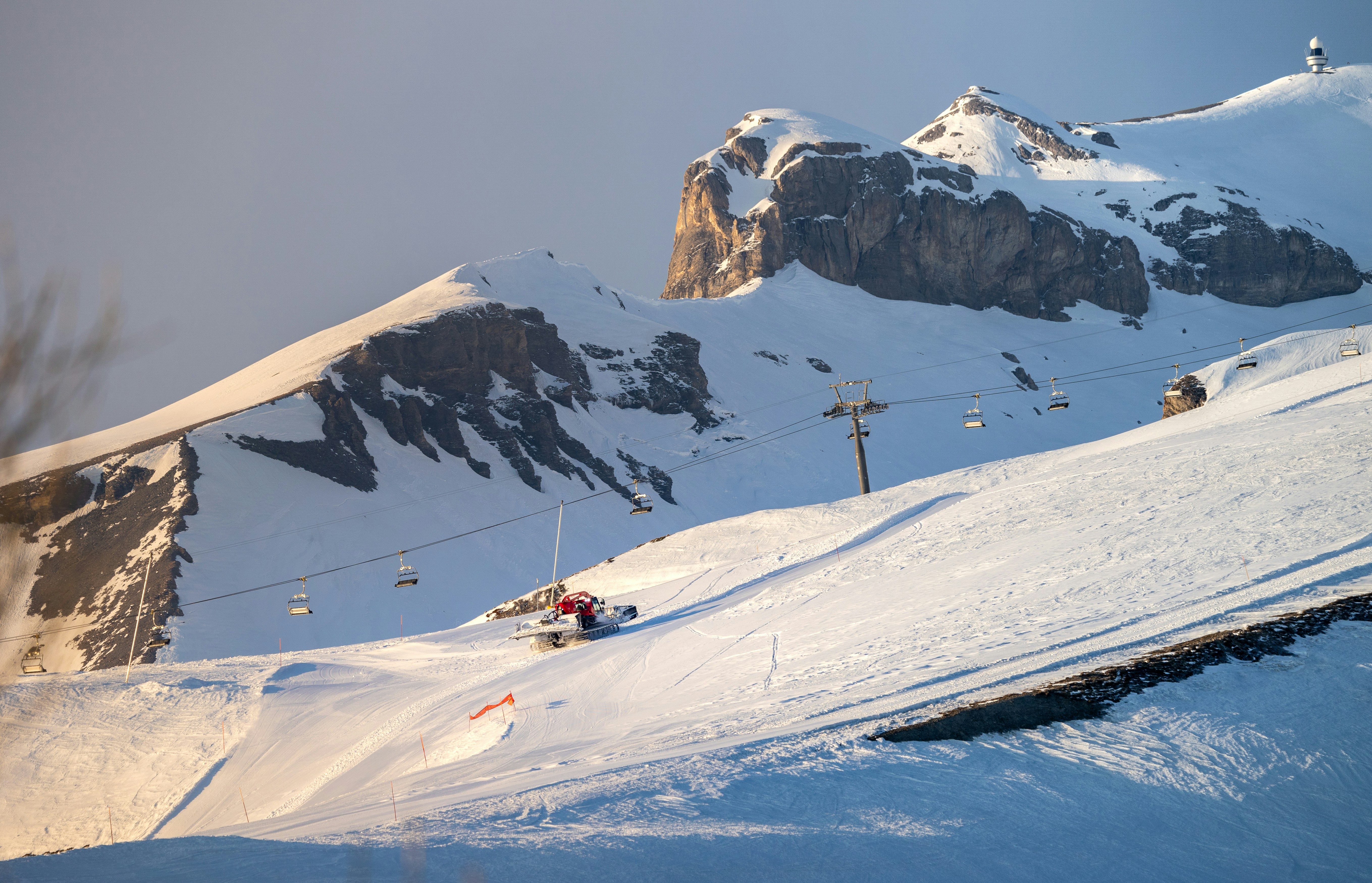 Snowy mountain slopes with ski lifts and distant peaks