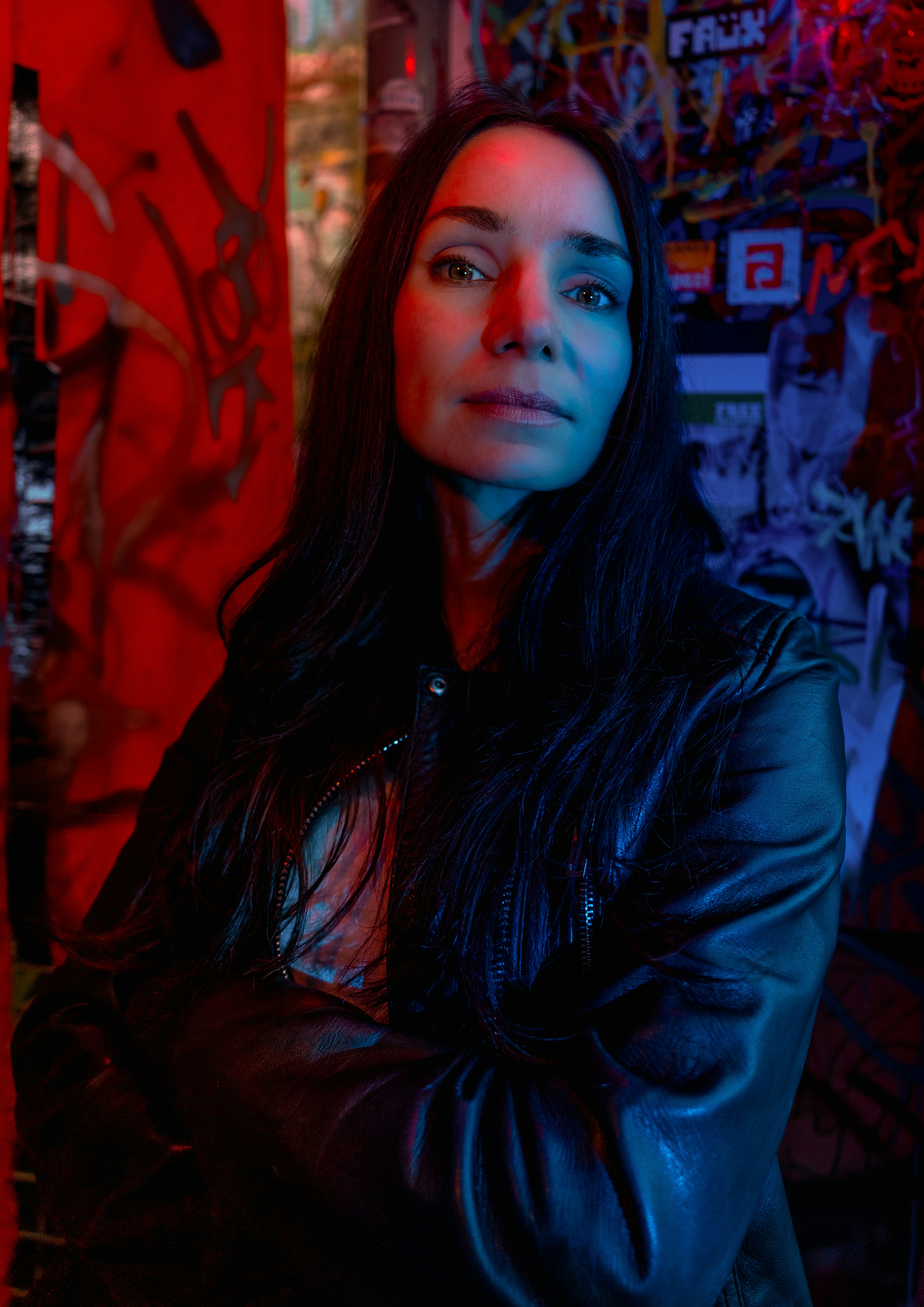 Woman in leather jacket with arms crossed