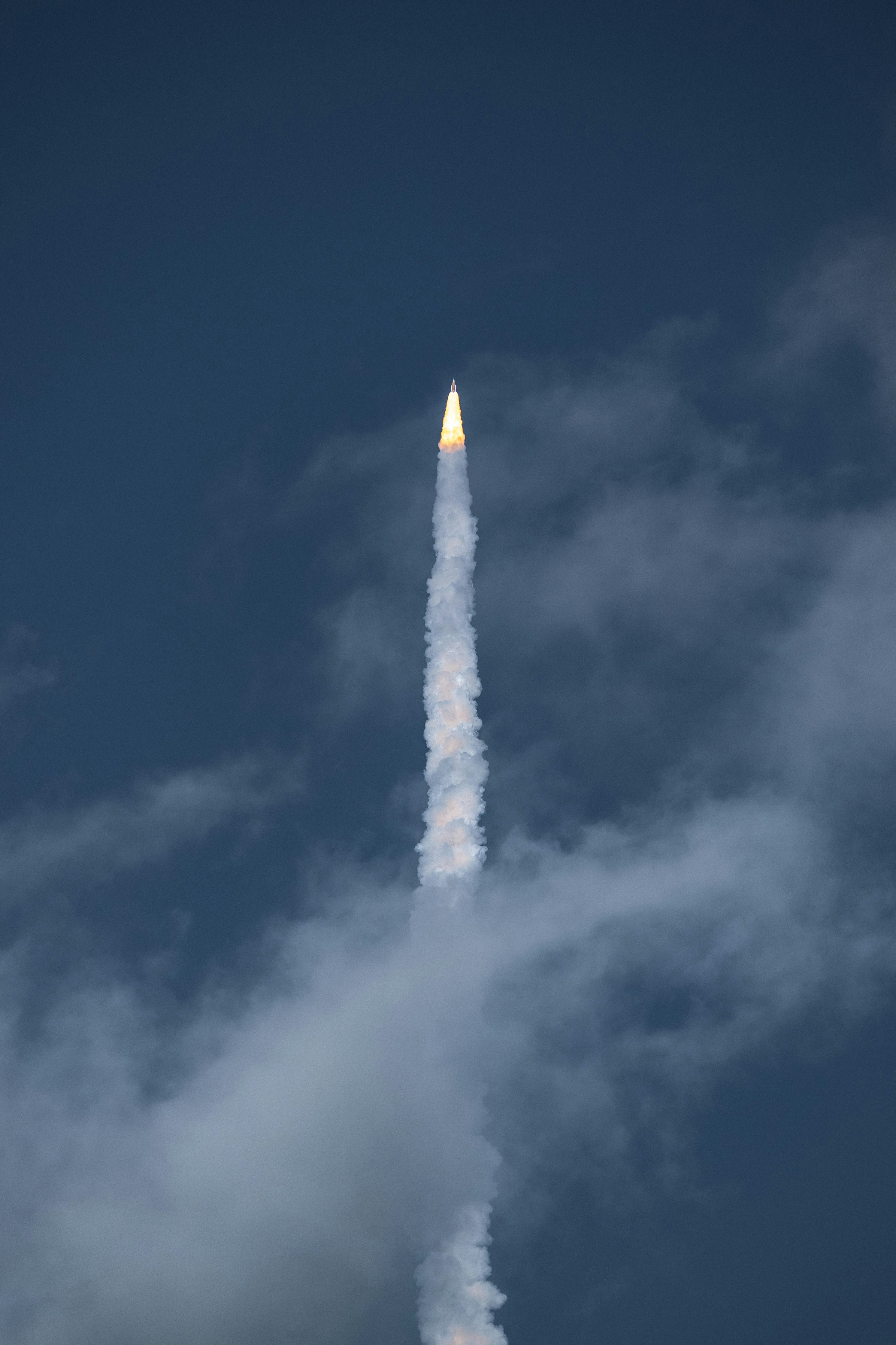 Rocket launching into a cloudy sky