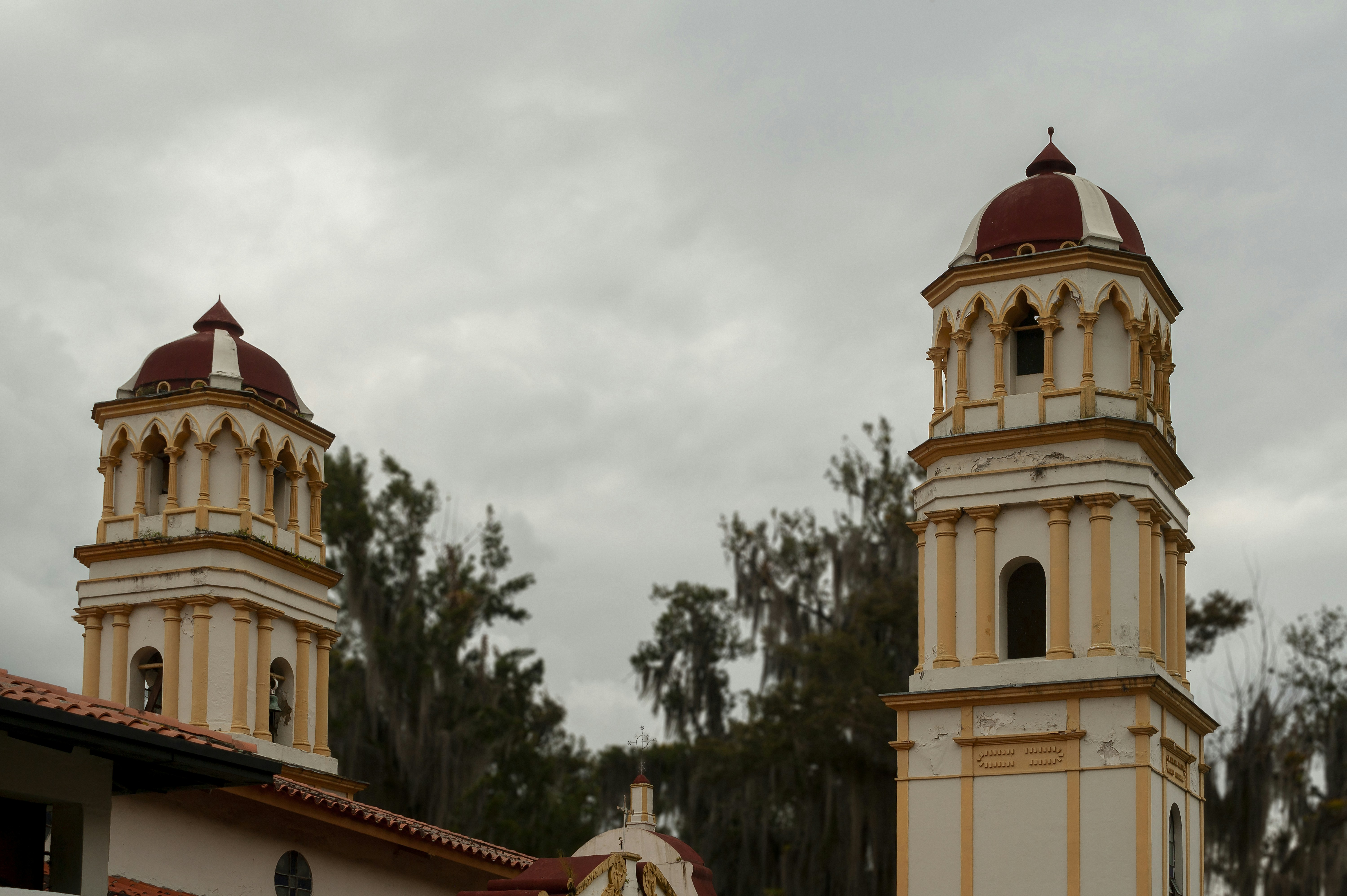 Two ornate church towers against a cloudy sky