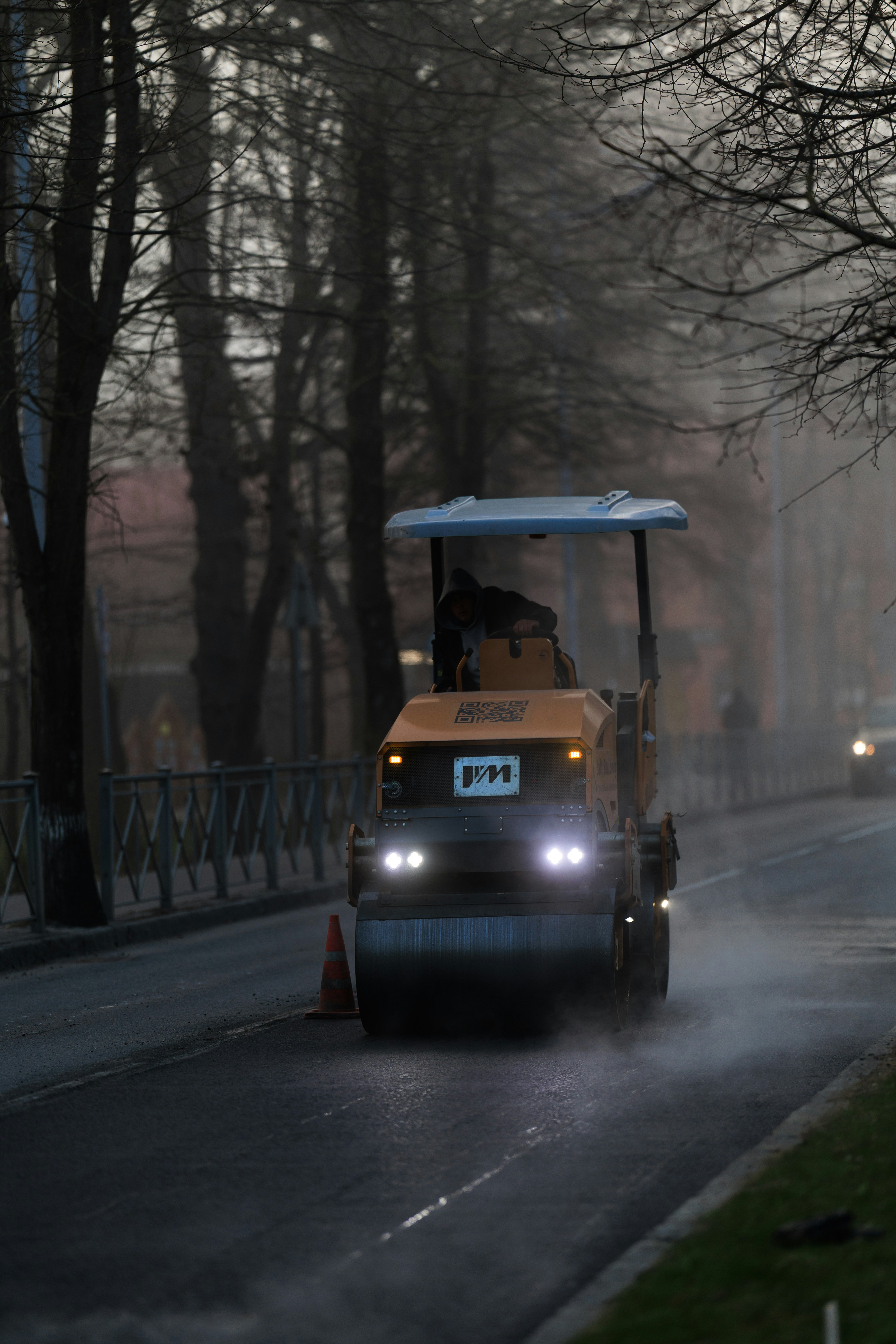 Road roller compacting asphalt on a street