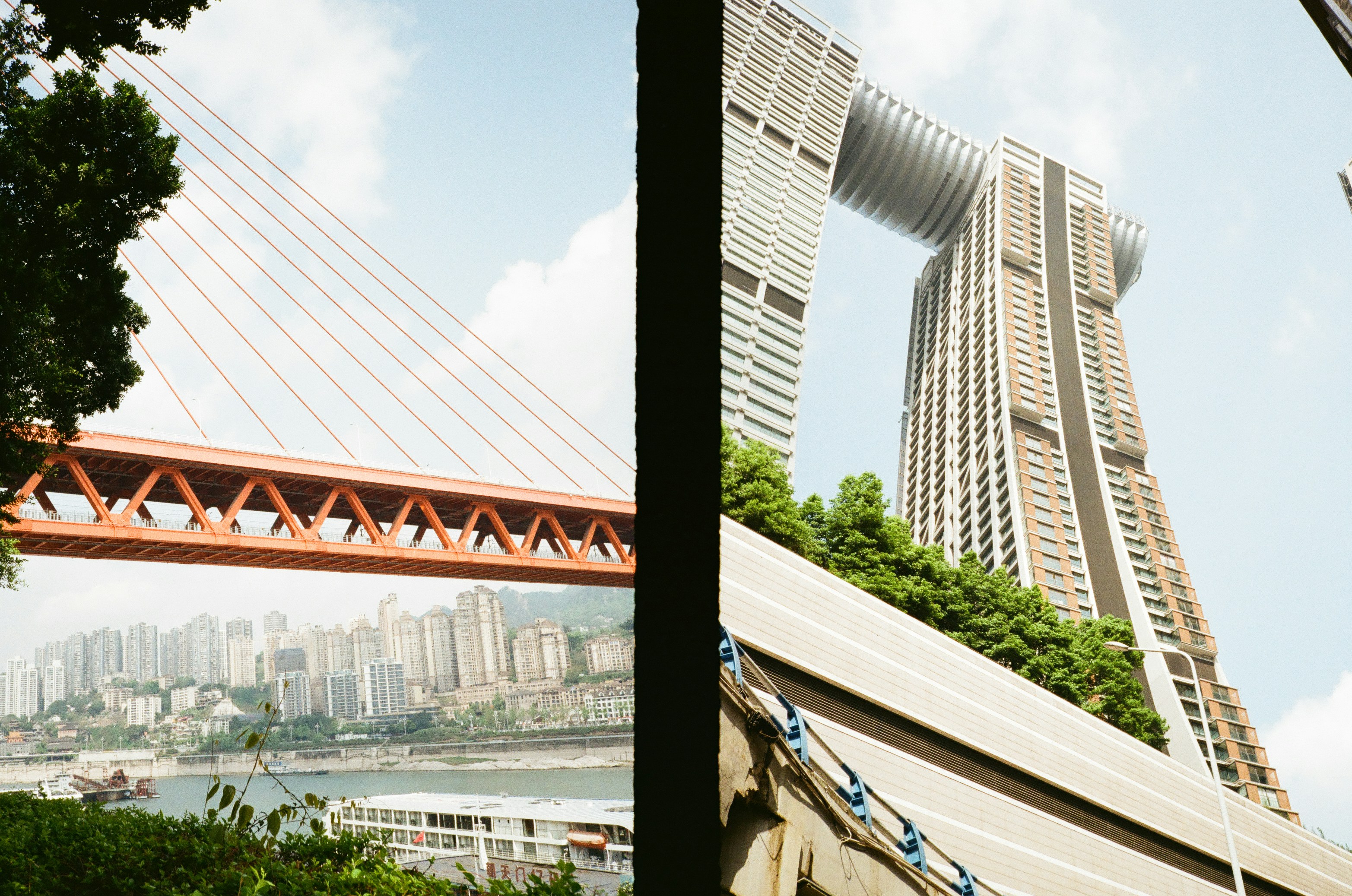 Modern skyscrapers and orange bridge over river