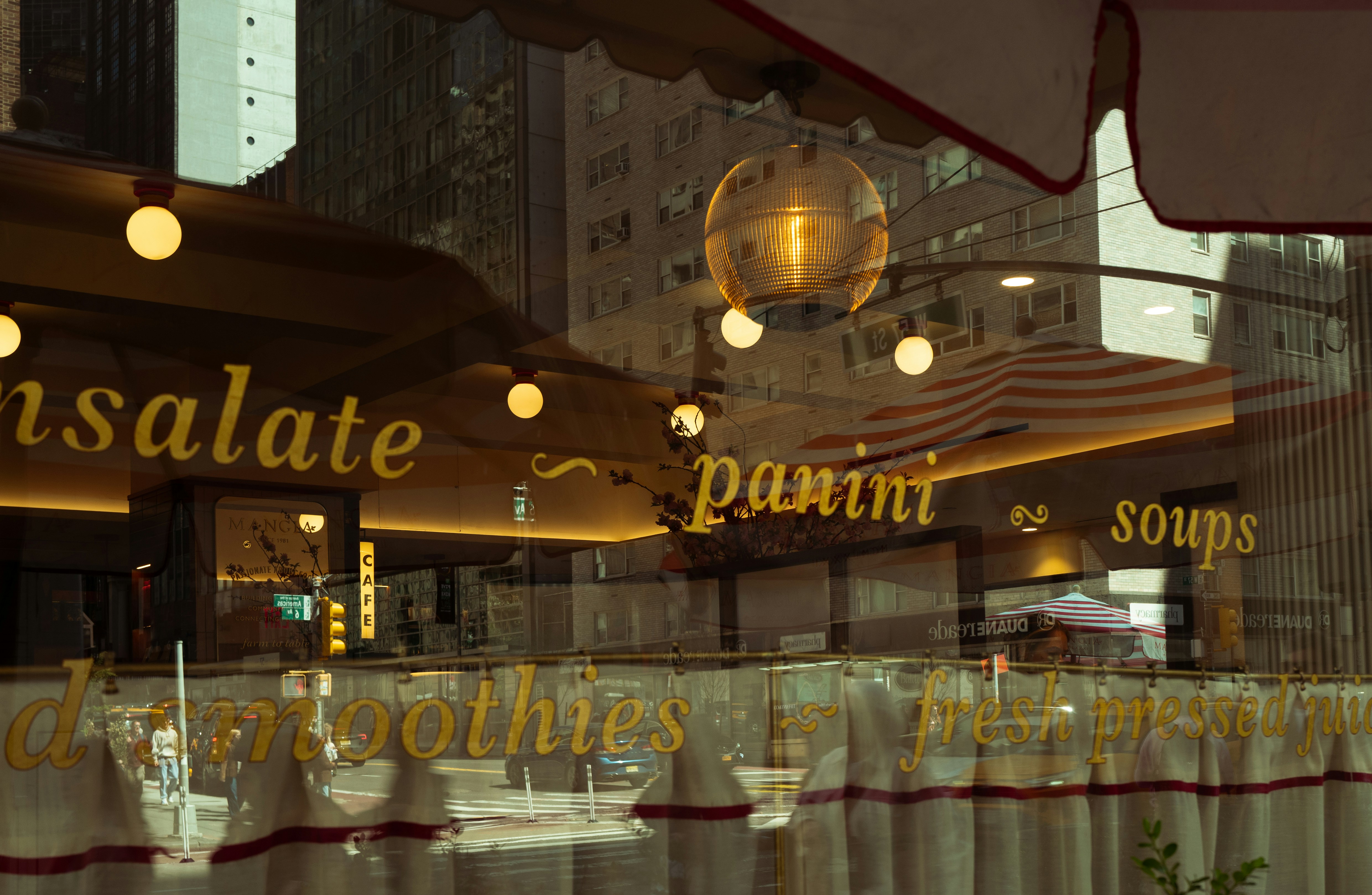 Restaurant window with menu items and reflections