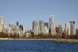 Modern city skyline with waterfront and clear blue sky