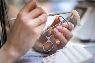 Dentist crafting a dental prosthesis with tools