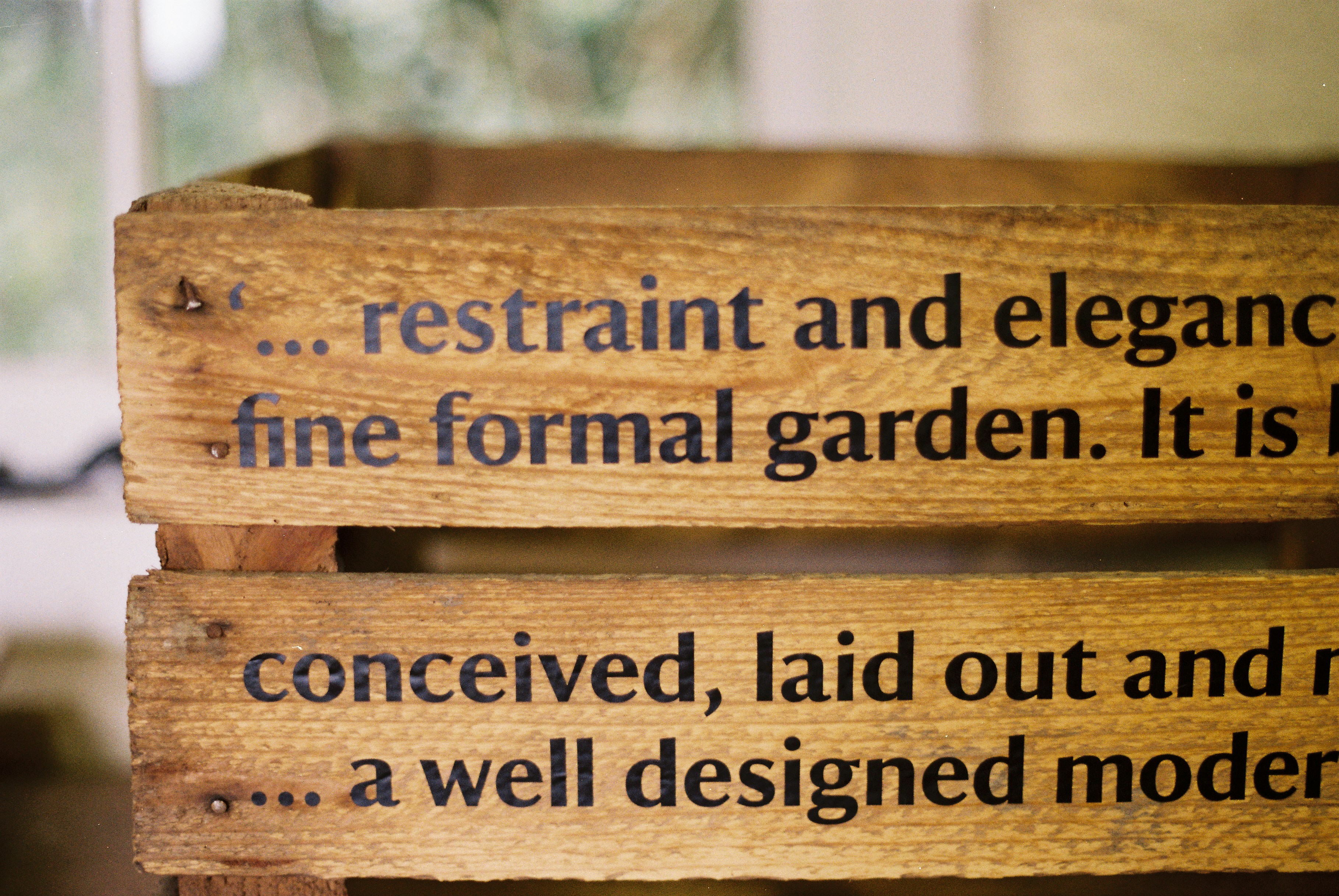 Wooden crate with text about gardens