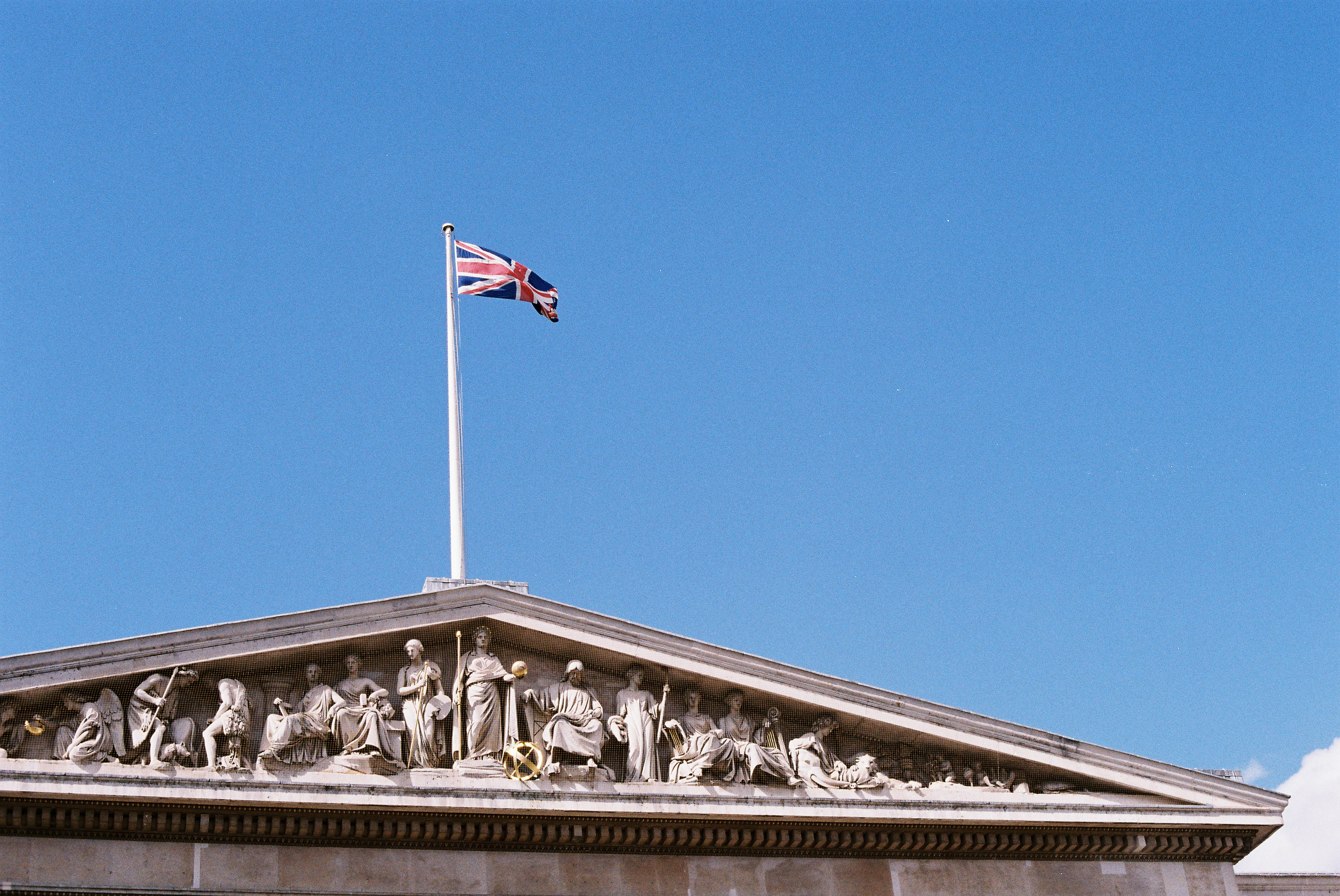 British flag flies over a building pediment