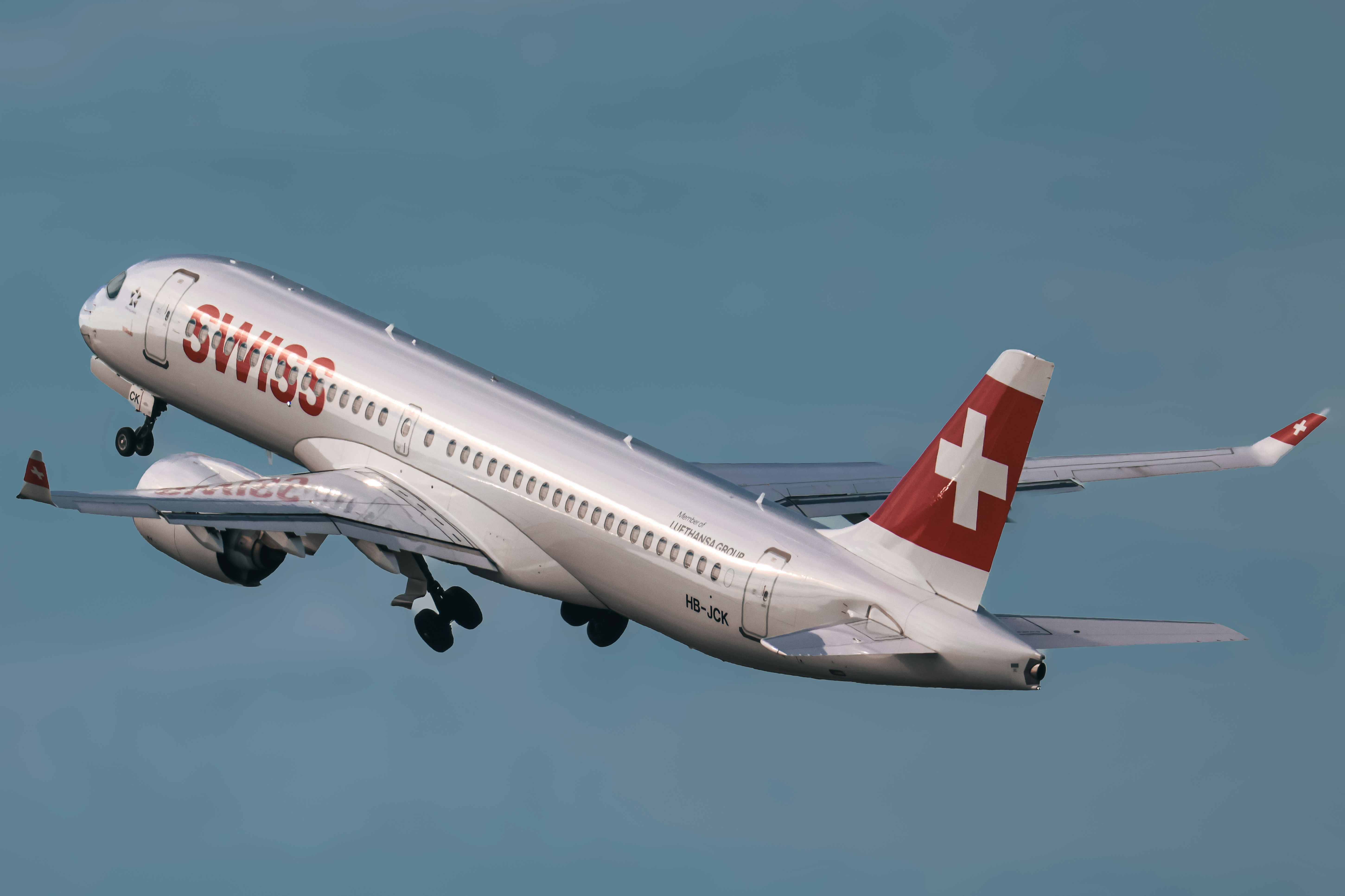 A swiss airplane taking off into the sky