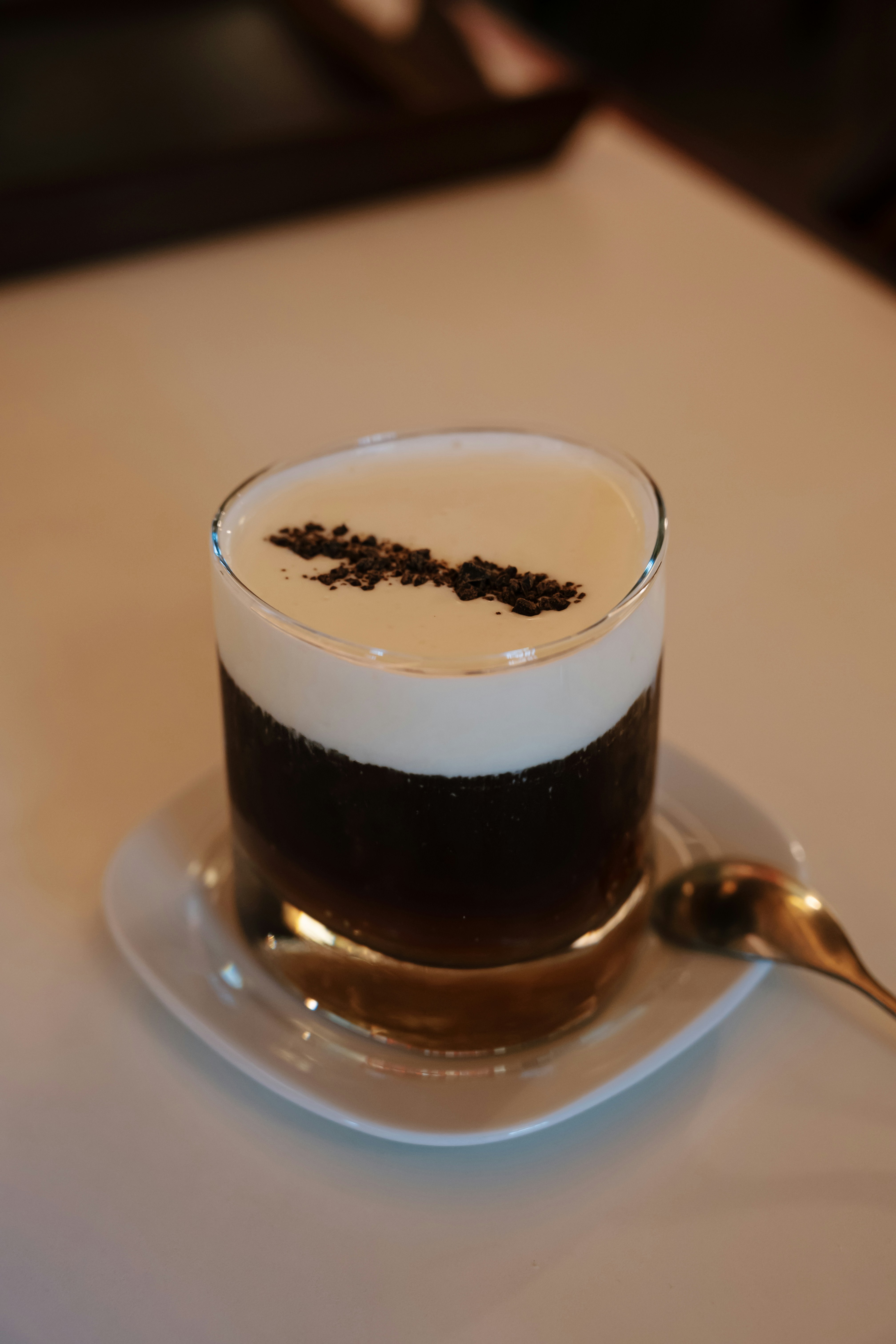 A creamy coffee drink with dark chocolate shavings.