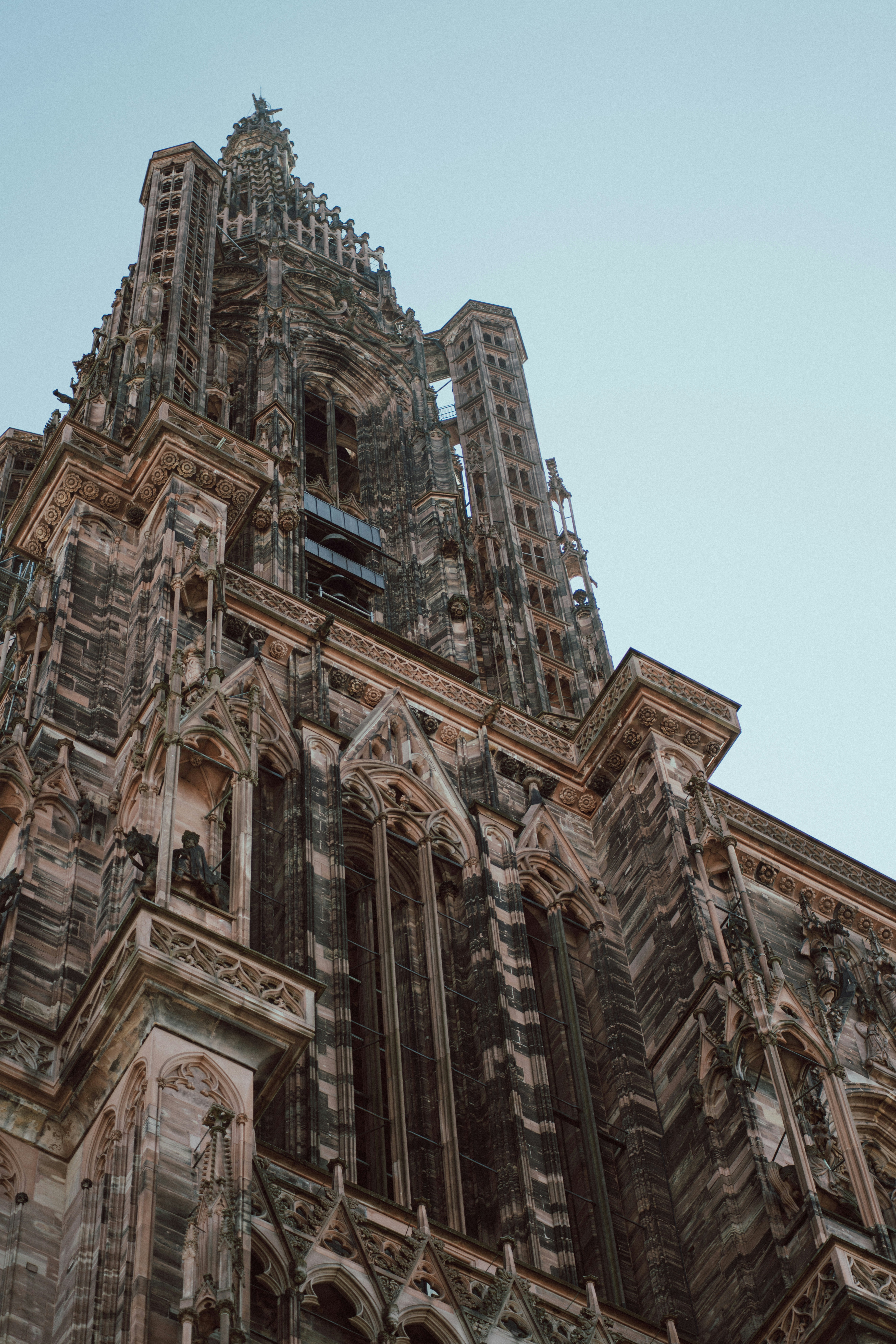 Gothic cathedral spire against a clear sky.