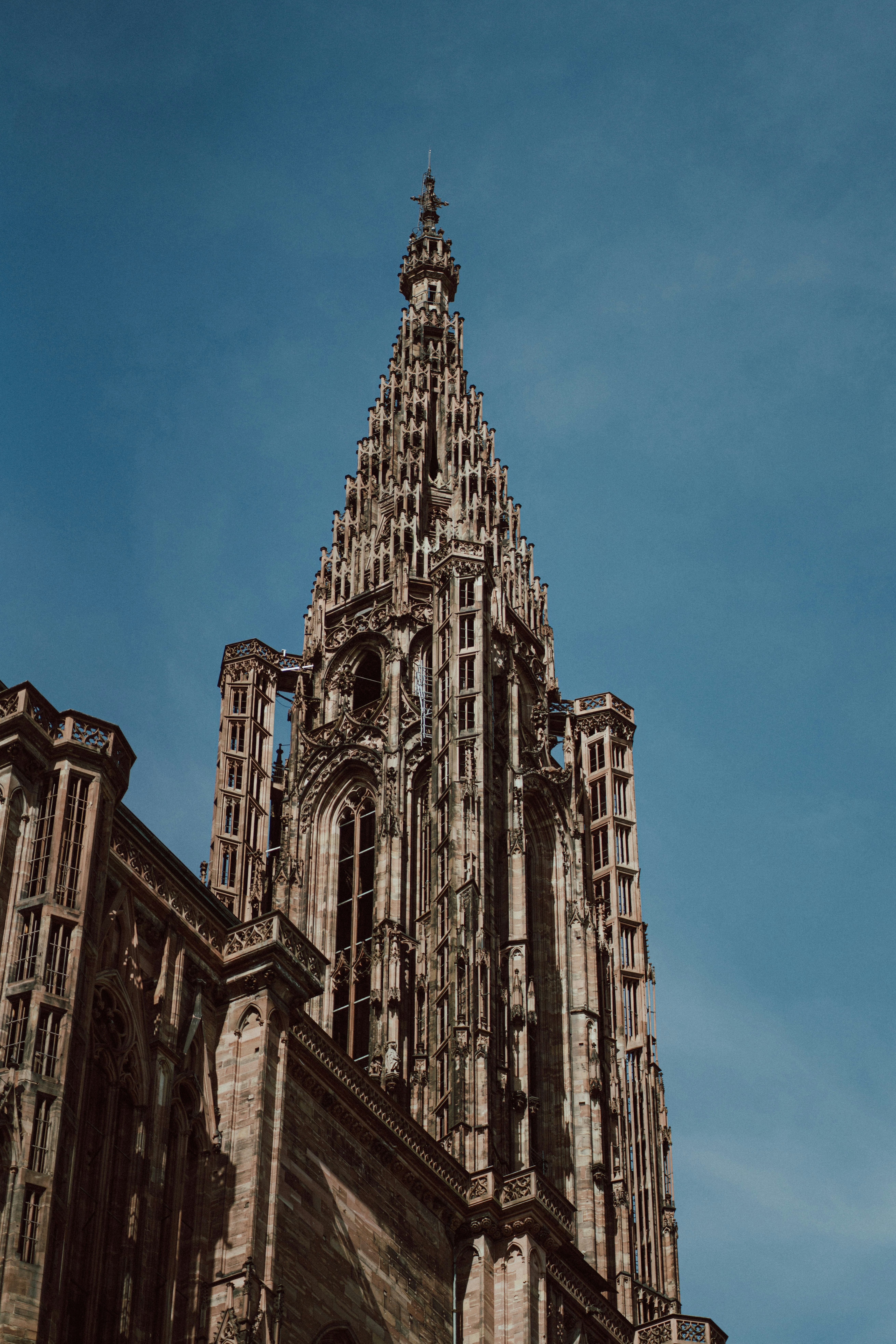 Gothic cathedral spire against a clear blue sky
