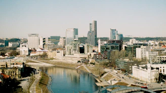 Modern cityscape with river and buildings on a sunny day