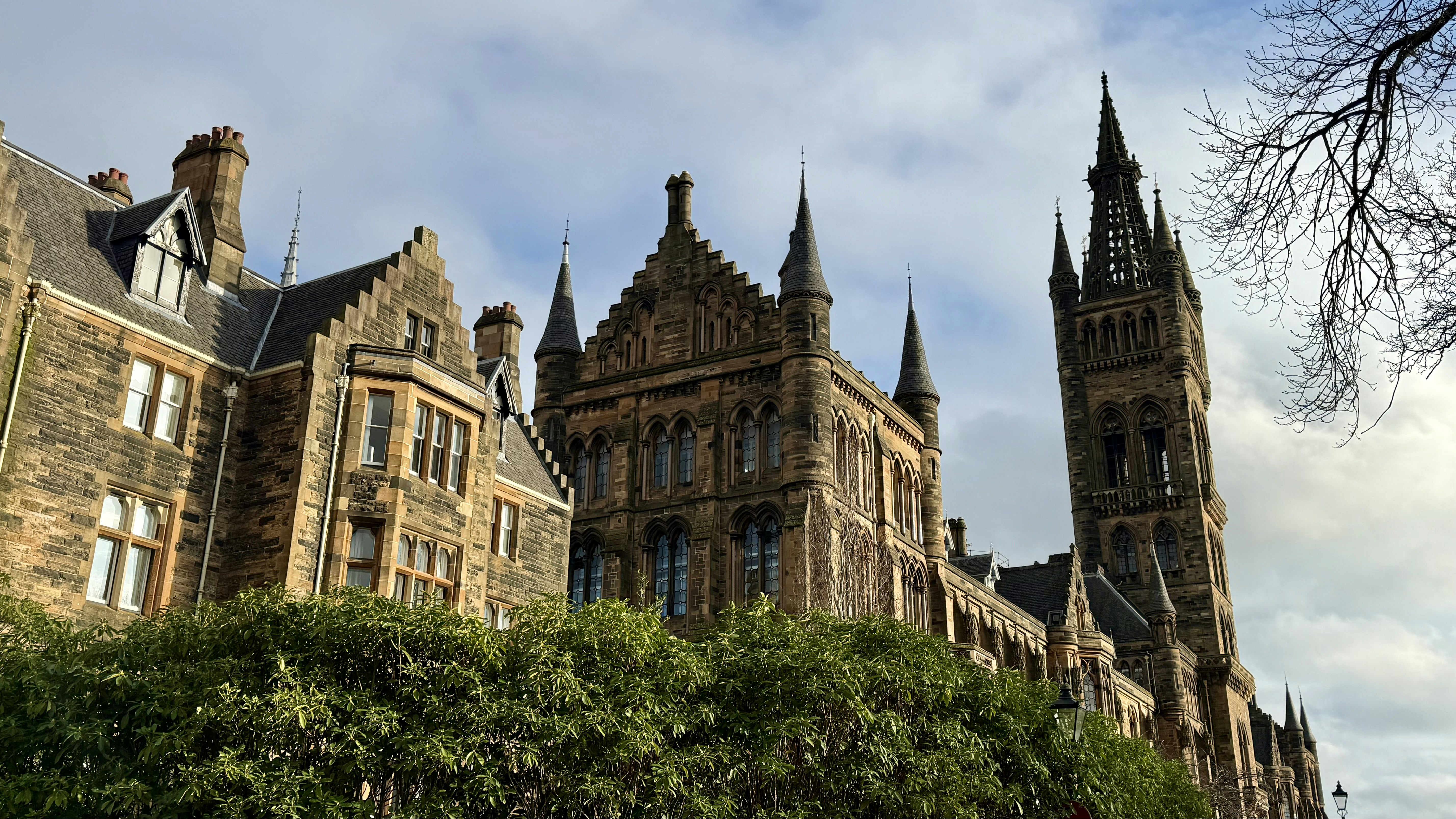 Historic stone building with tall spires under sky