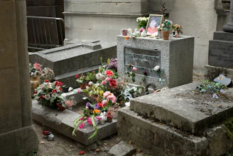 A grave adorned with flowers and a framed picture.
