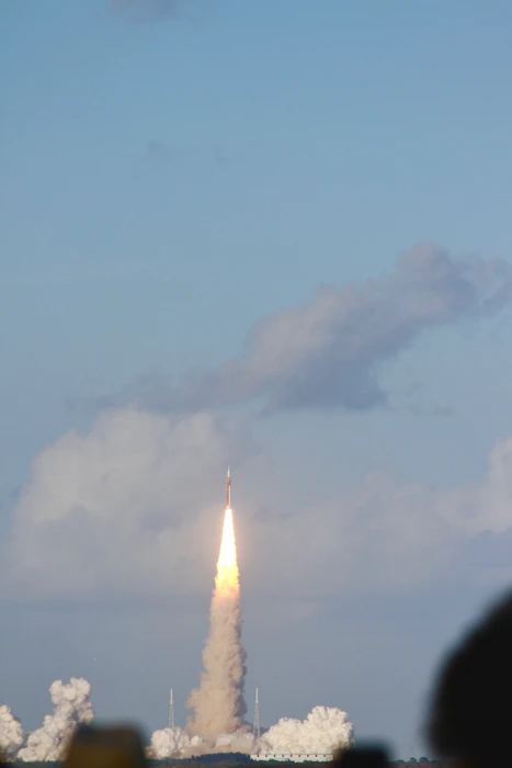 Rocket launching into cloudy sky