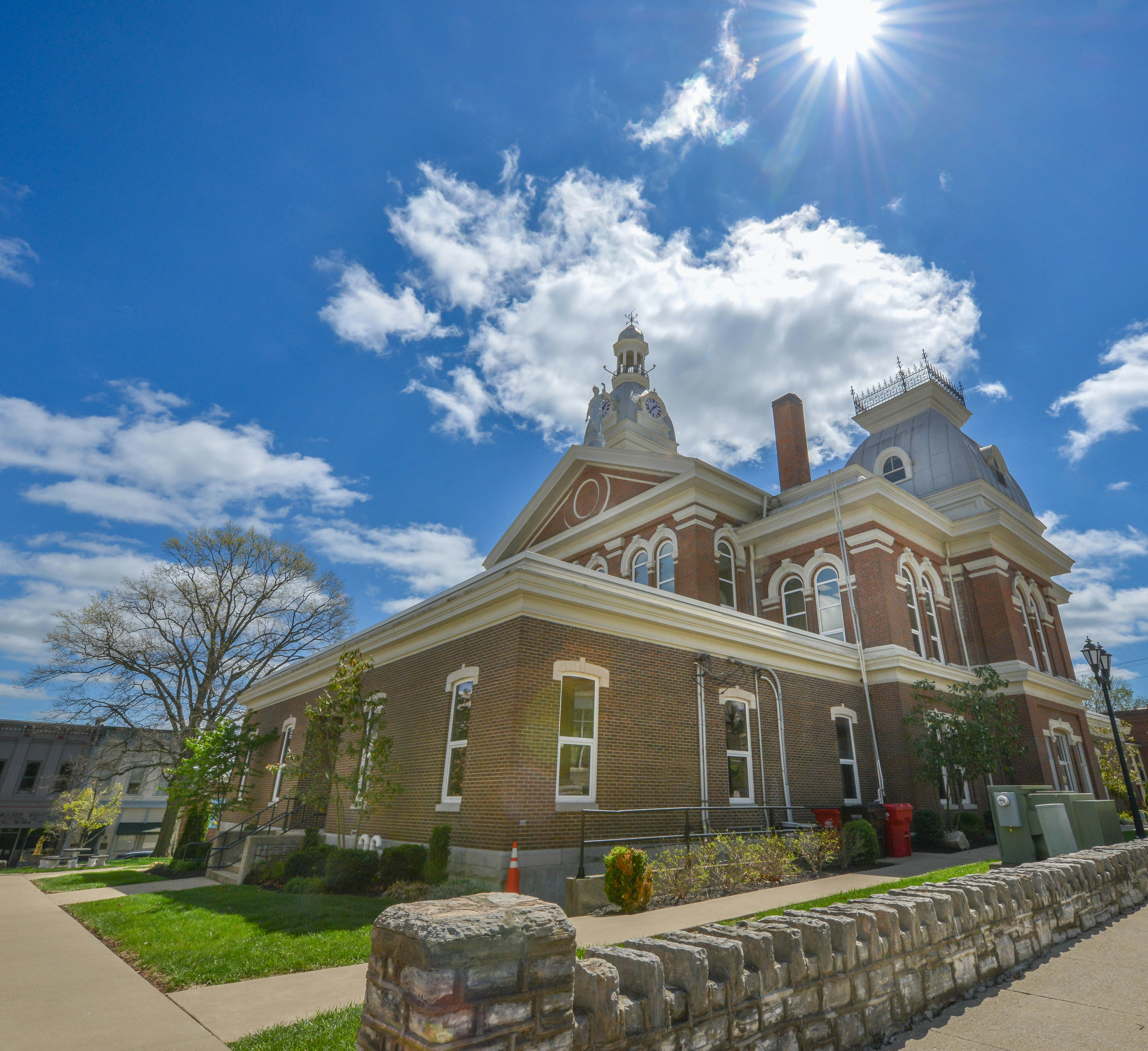 Historic brick courthouse under a bright sunny sky