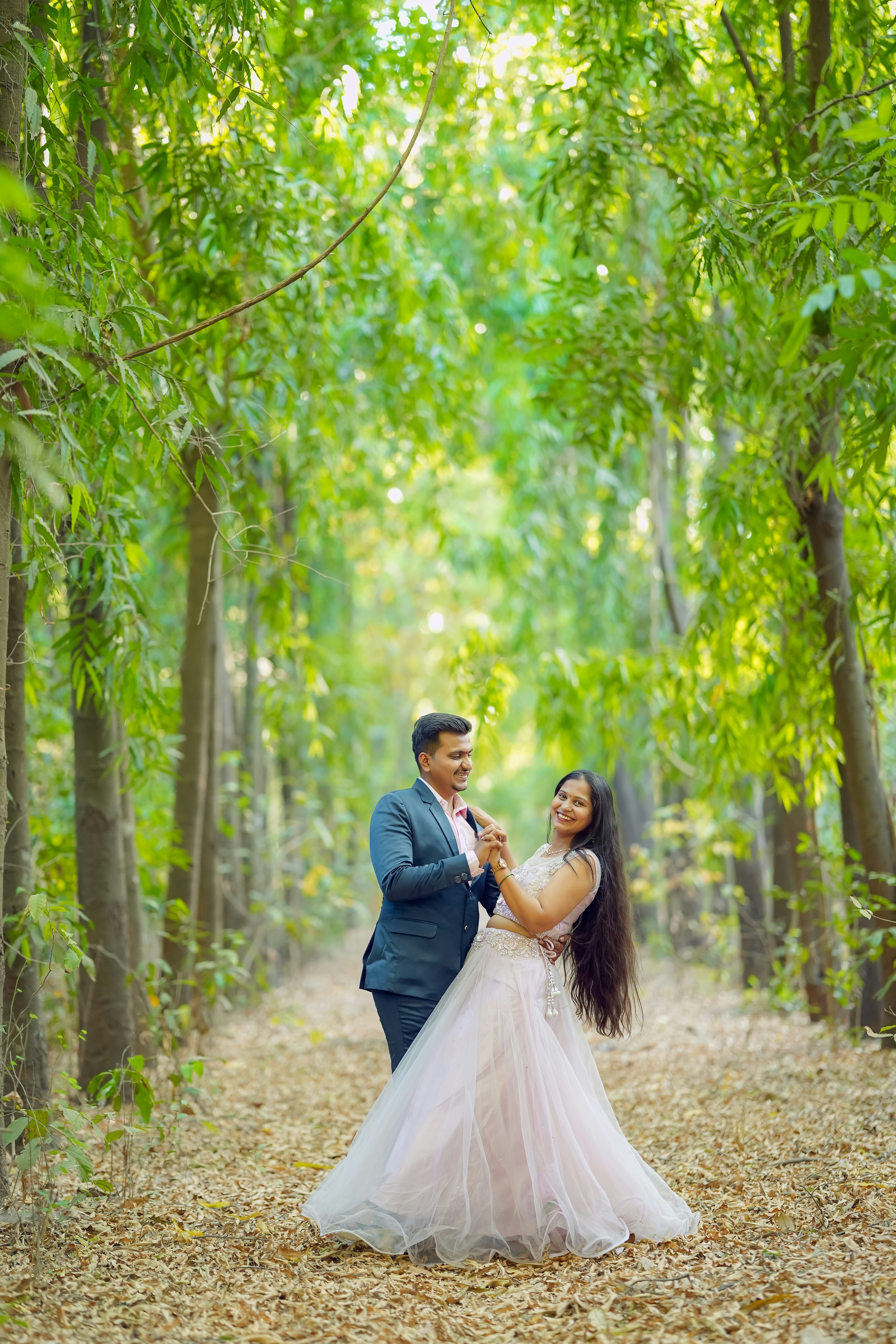 Couple dancing in a sunlit forest