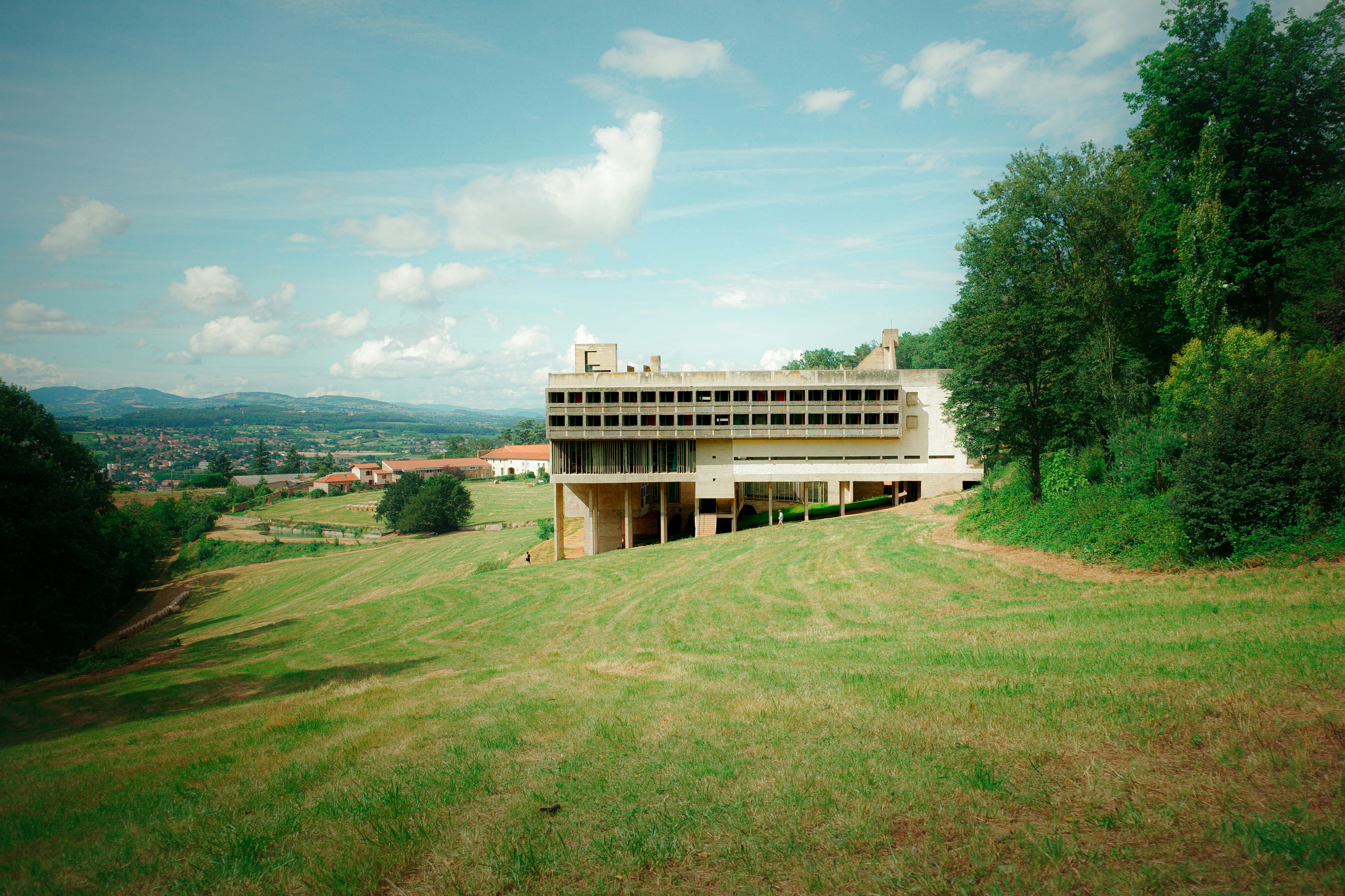Modern building on a grassy hill overlooking town