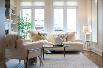A bright, elegant living room with a sofa and armchair.