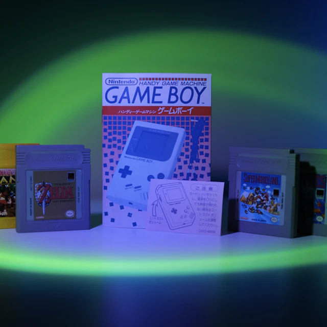 Nintendo Game Boy console displayed alongside a row of game cartridges