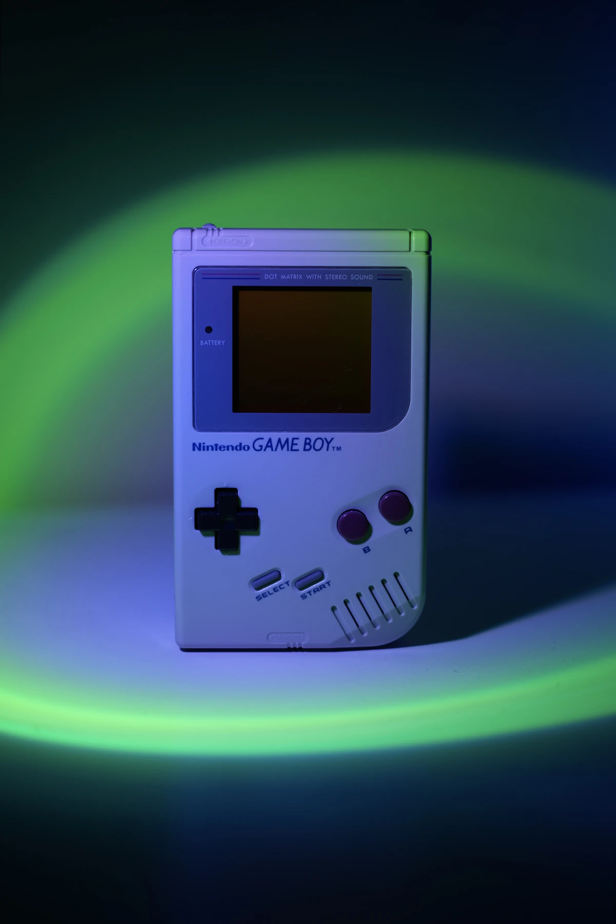 A white Game Boy with colourful neon lighting — pure 90s nostalgia