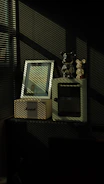 Shadows fall on framed picture and bear figurines.