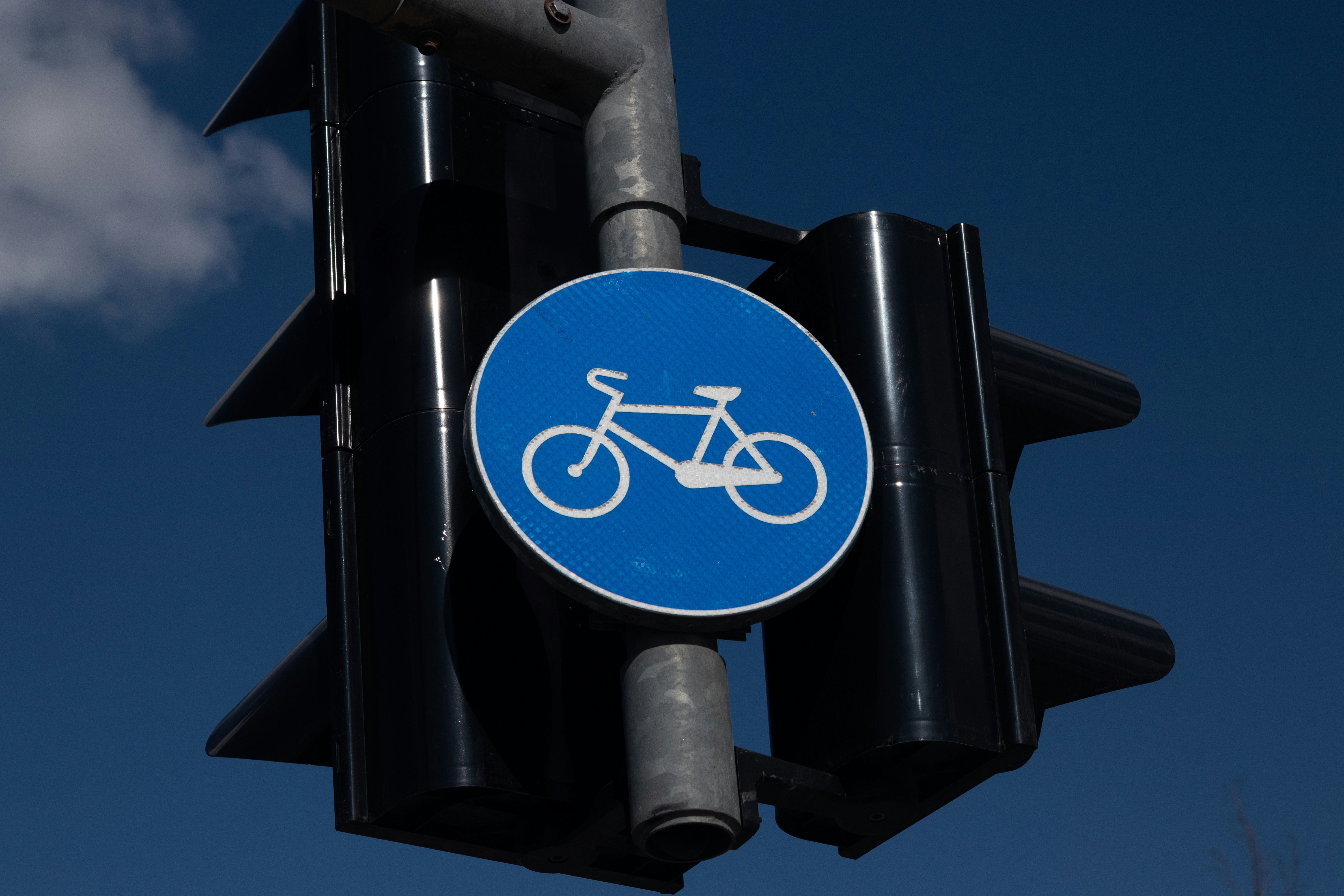 Blue bicycle lane sign on traffic light