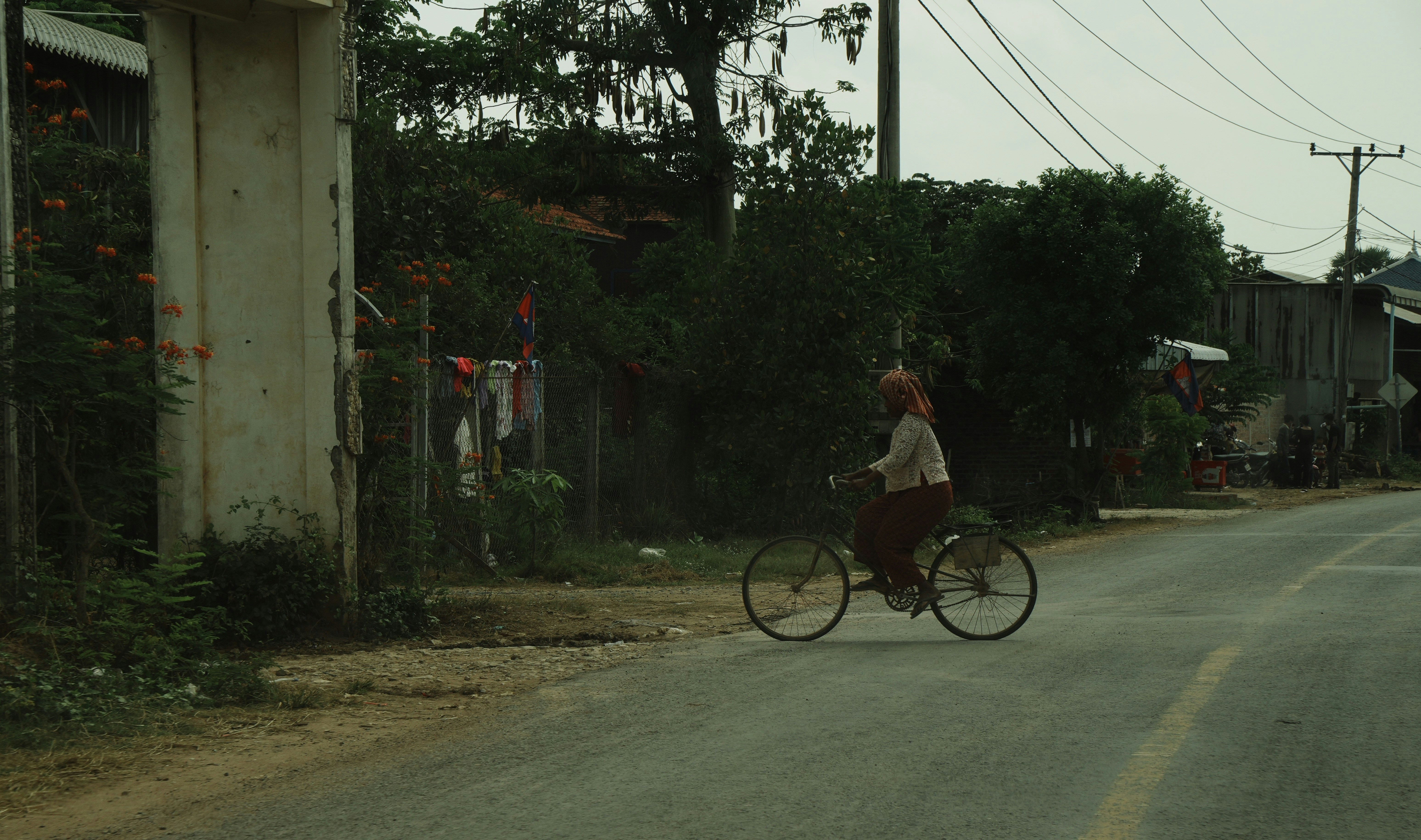 Person riding a bicycle on a rural road.