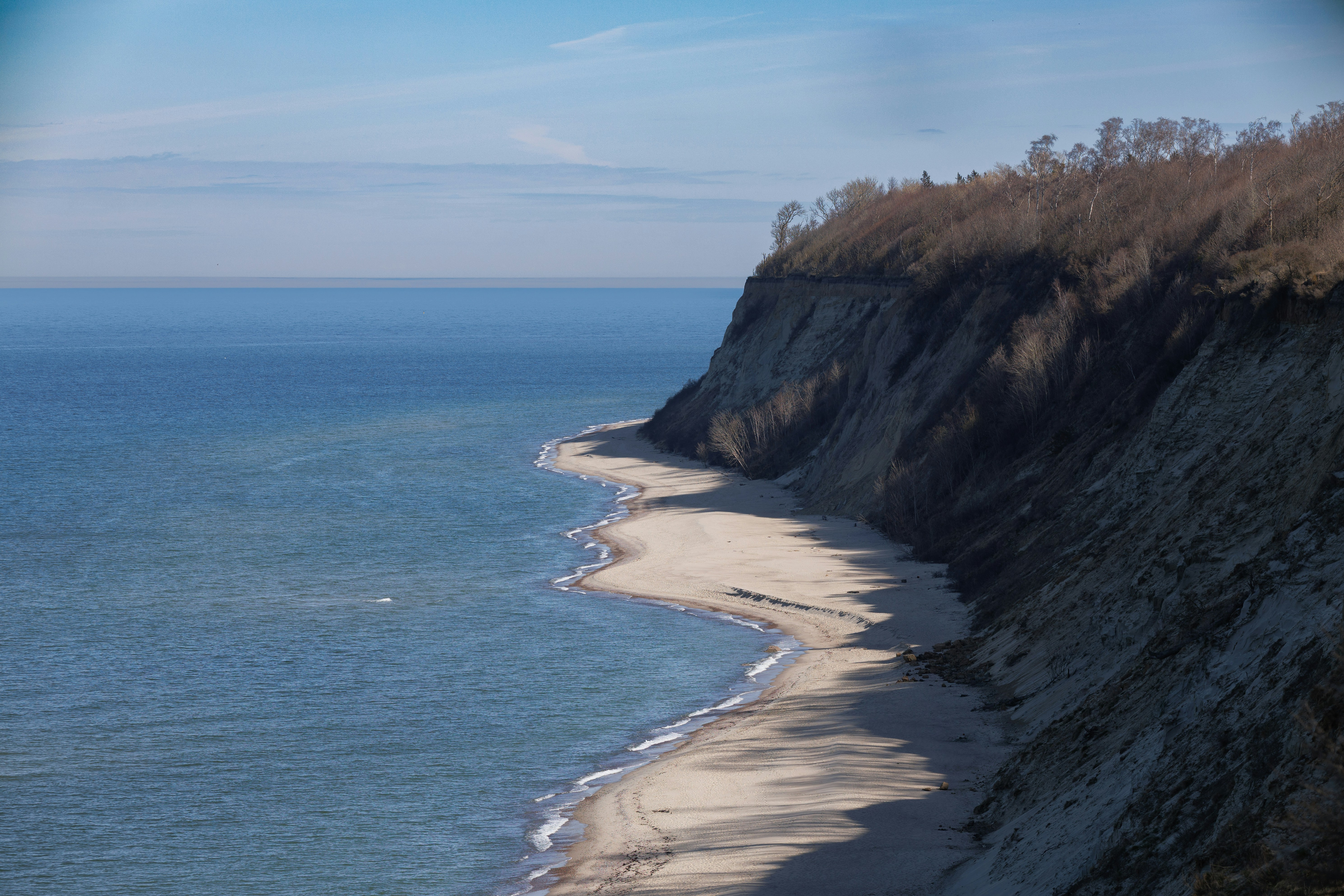 Coastal cliffs overlooking a sandy beach and ocean