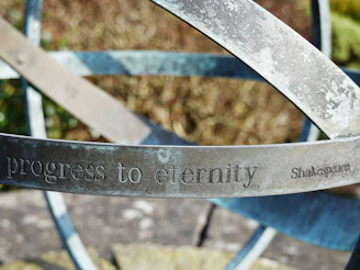 Engraved metal rings with "progress to eternity" text.