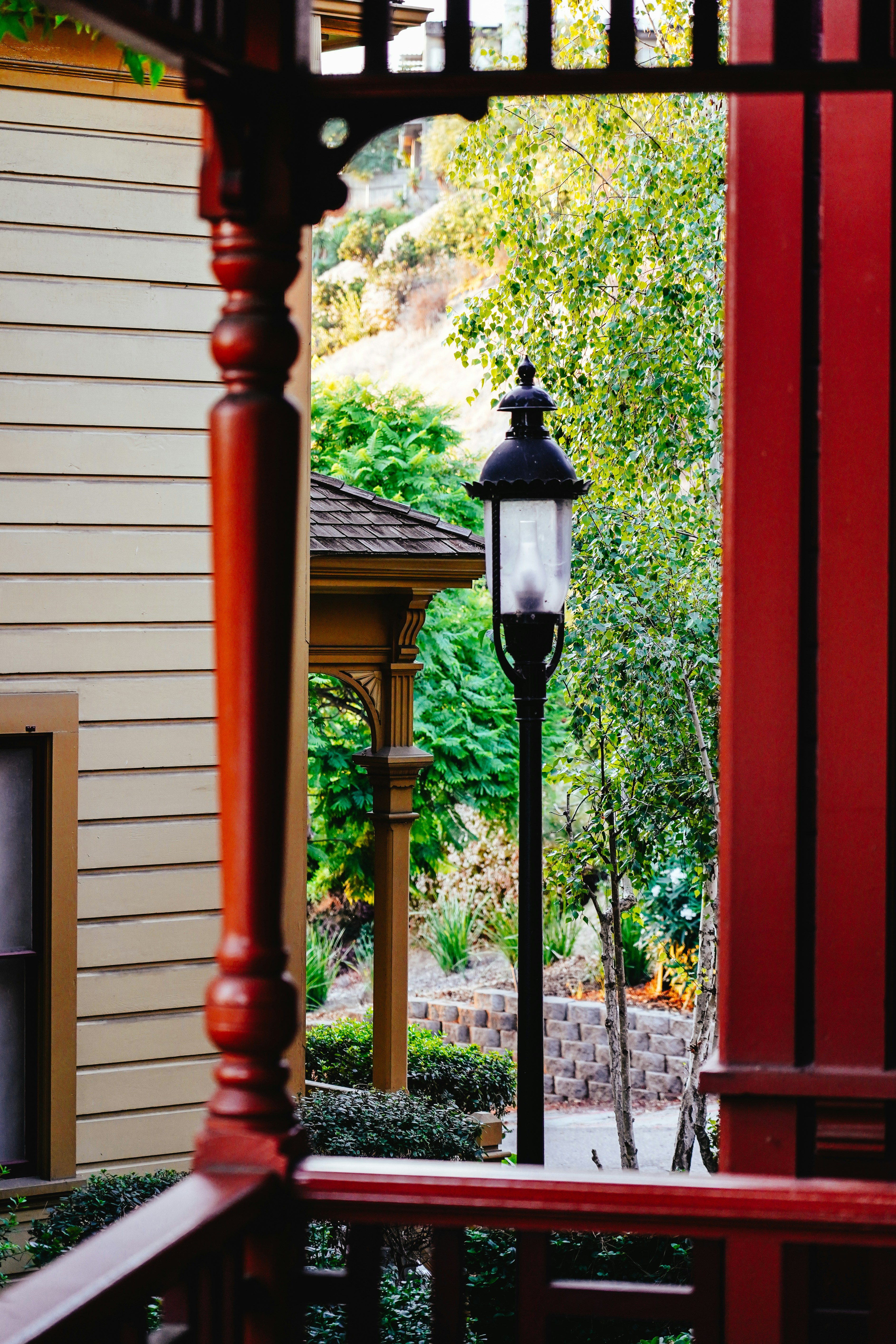 Ornate porch with a vintage lamppost in the background.
