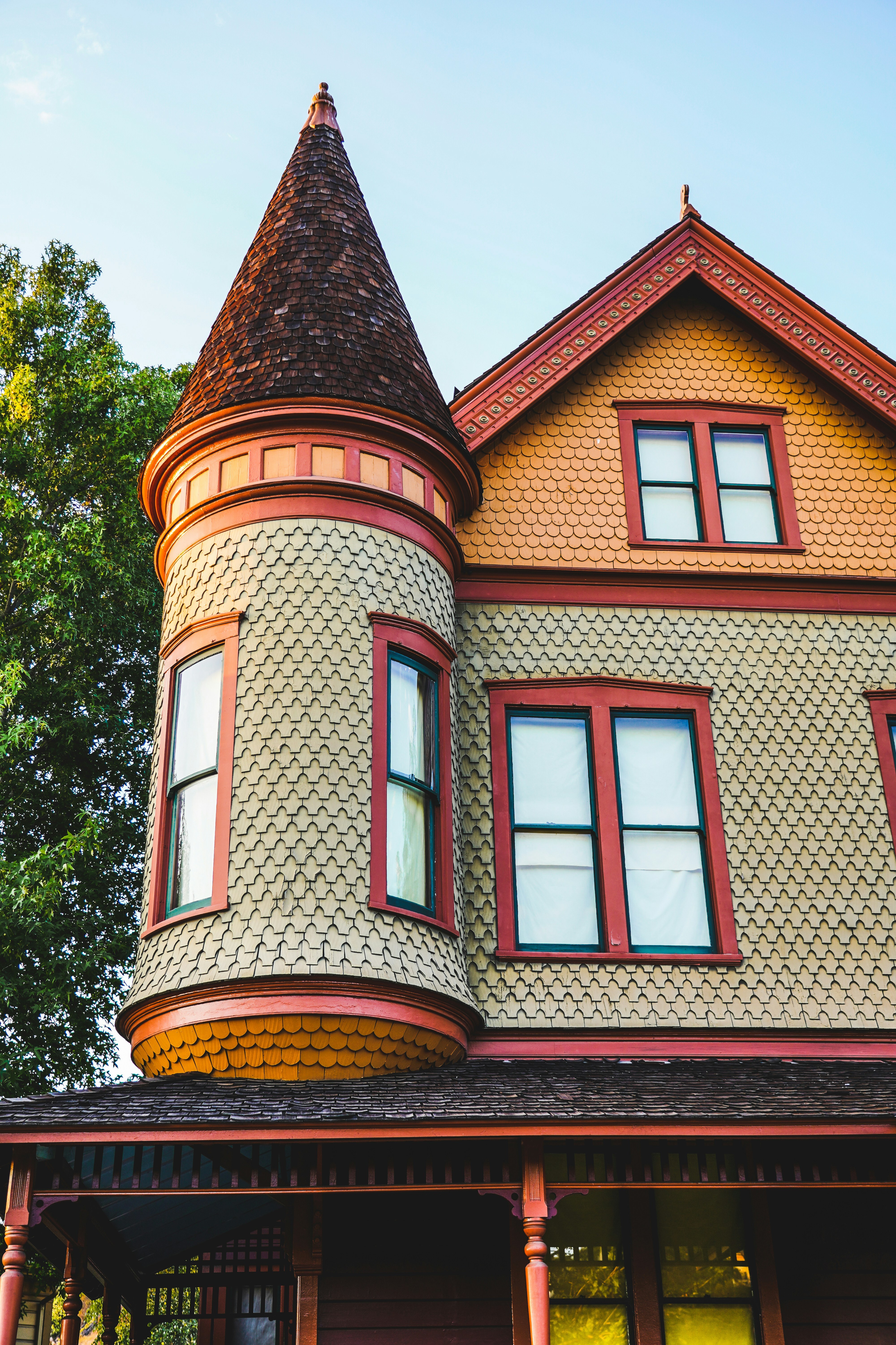 Victorian house with a conical turret and colorful siding