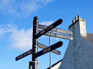 Directional signs point to town centre, library, and police station.