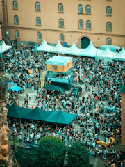 Crowded outdoor festival with tents and people