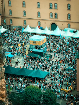 Crowded outdoor festival with tents and people