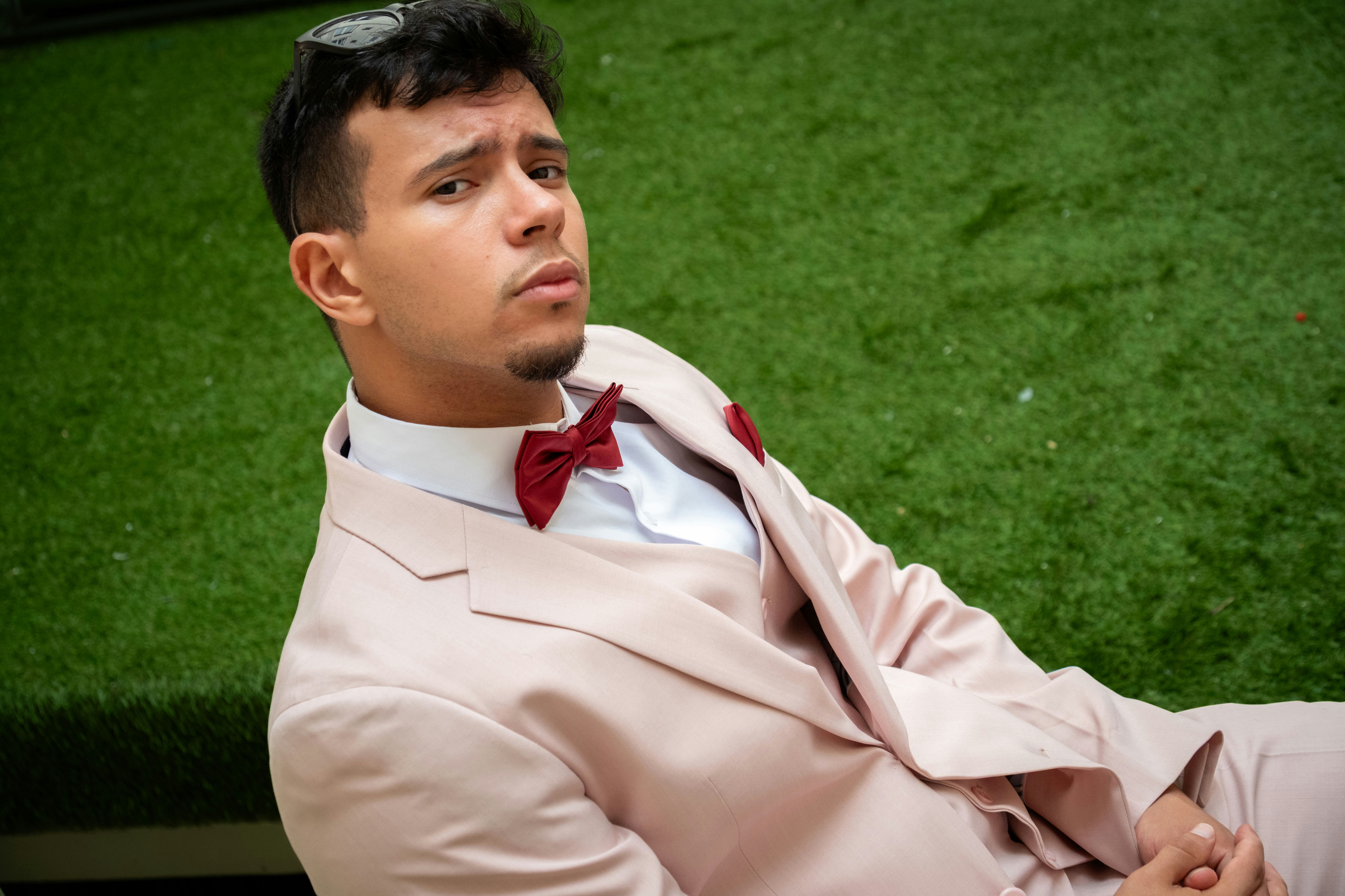 Man in a pink suit with a red bowtie