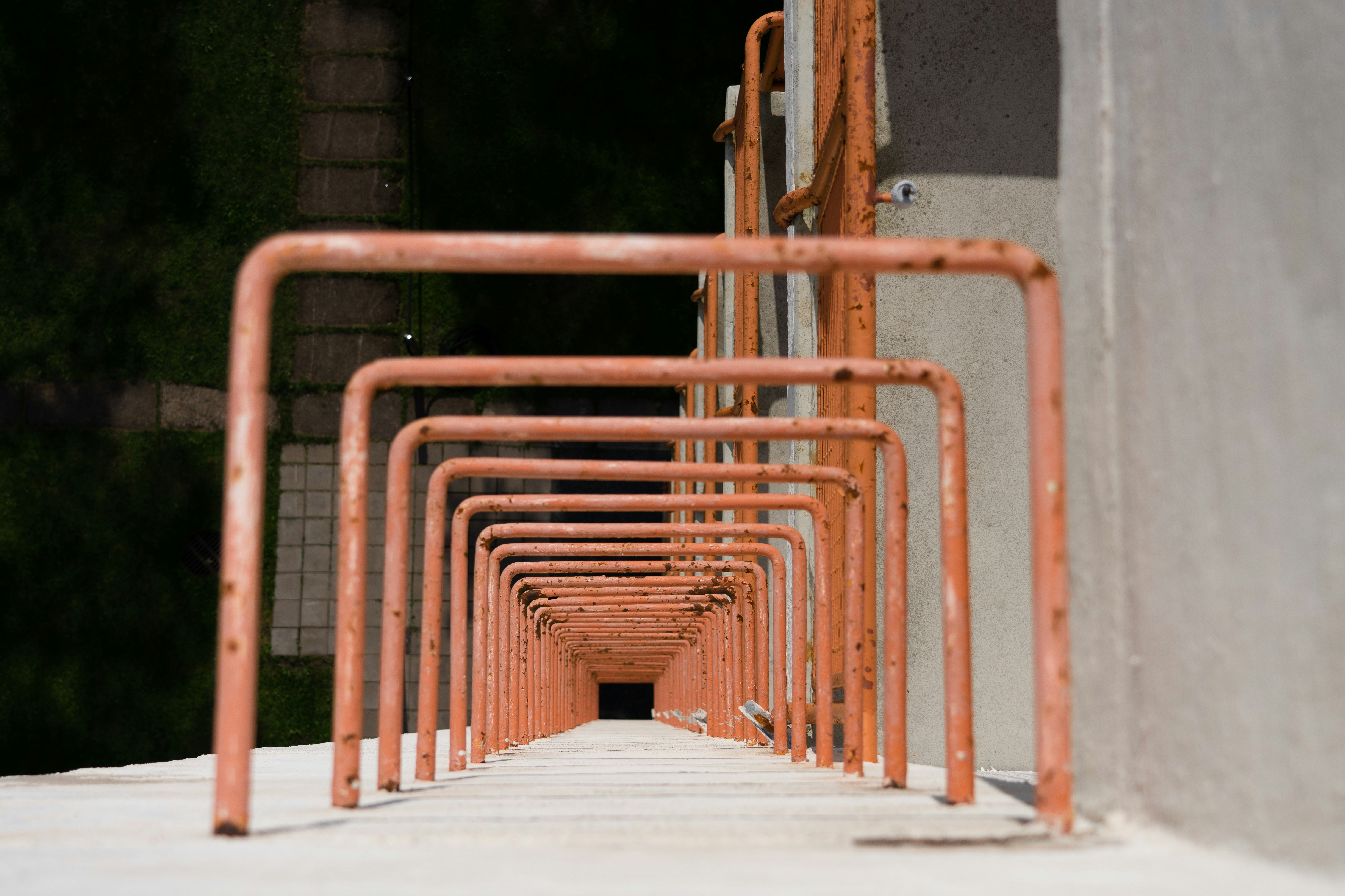 Orange metal ladder receding into darkness