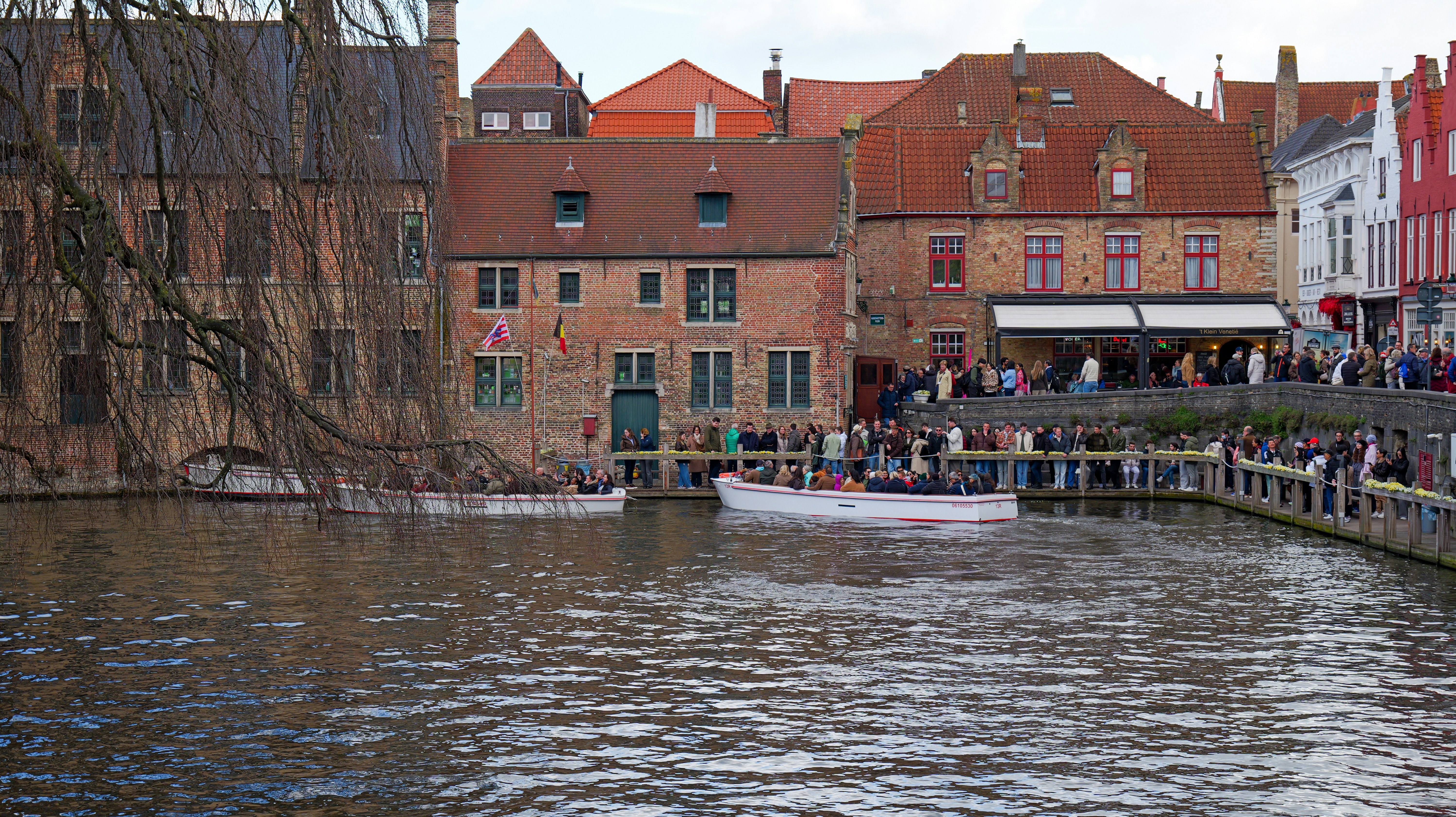 Boats on a canal with historic buildings and people. - boats-on-a-canal-with-historic-buildings-and-people-7Vfj-FBhyi4
