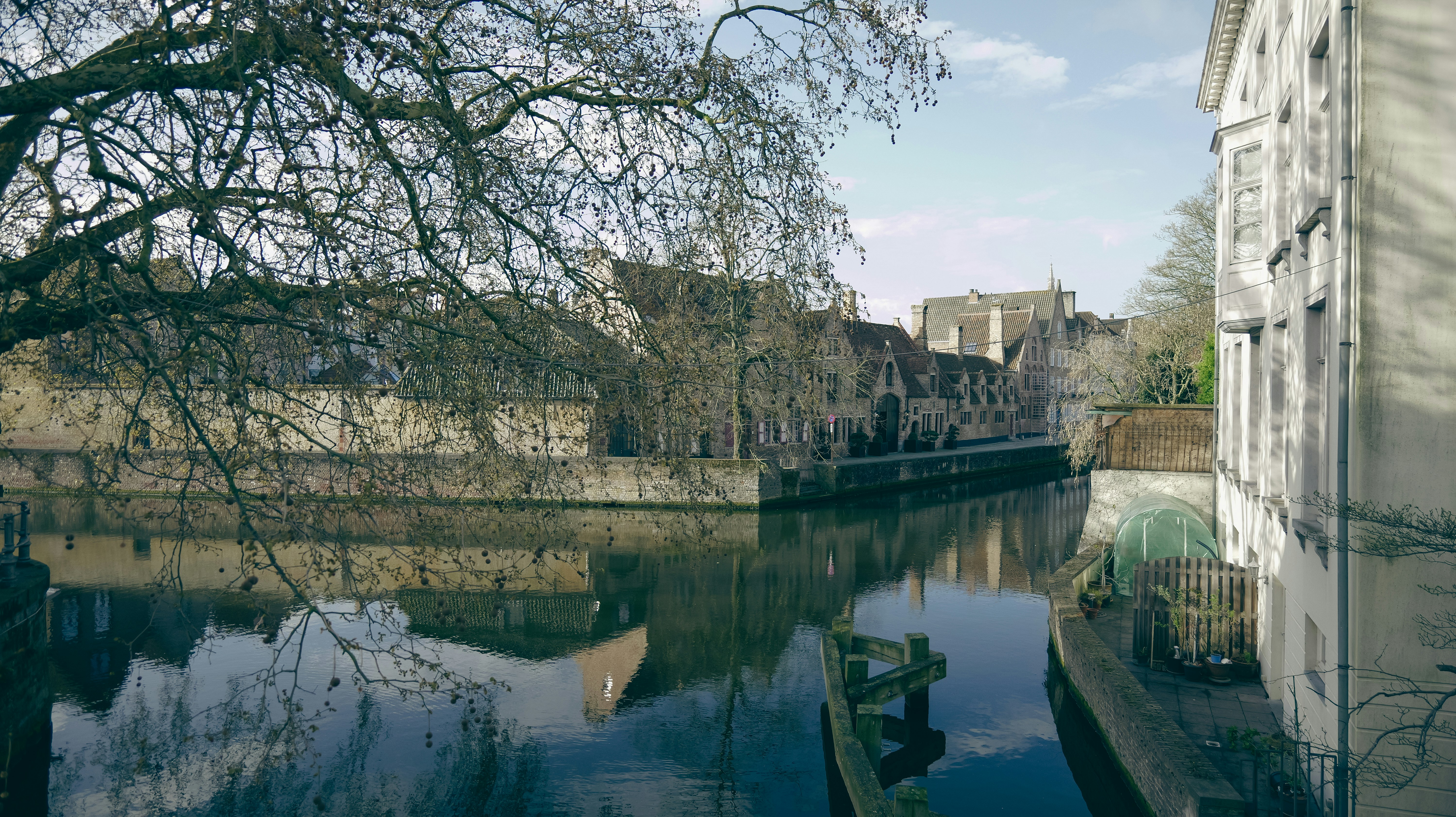 Canal with buildings and bare trees reflected - canal-with-buildings-and-bare-trees-reflected-C3kt9b_bcME