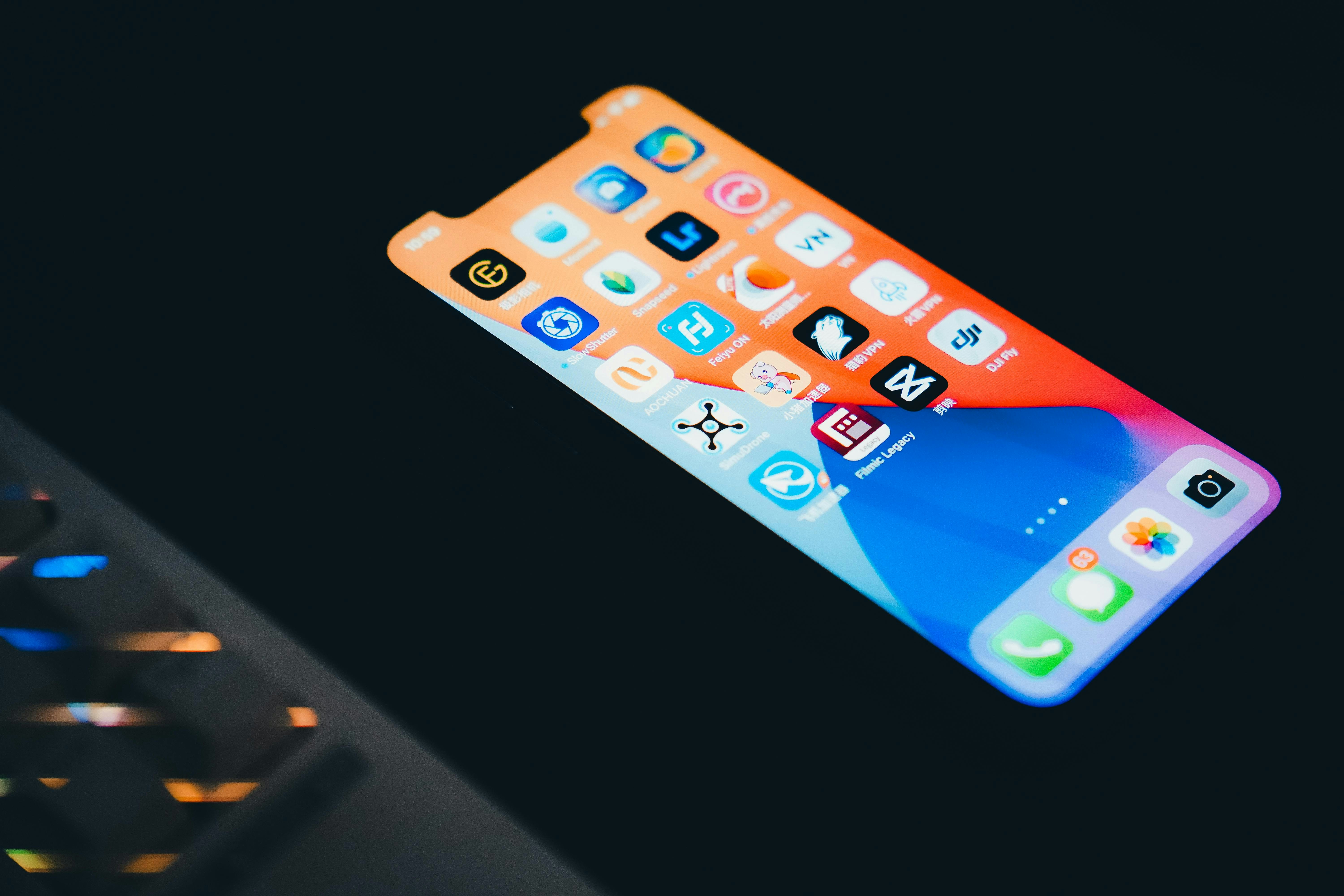 Smartphone displaying colorful app icons on dark background