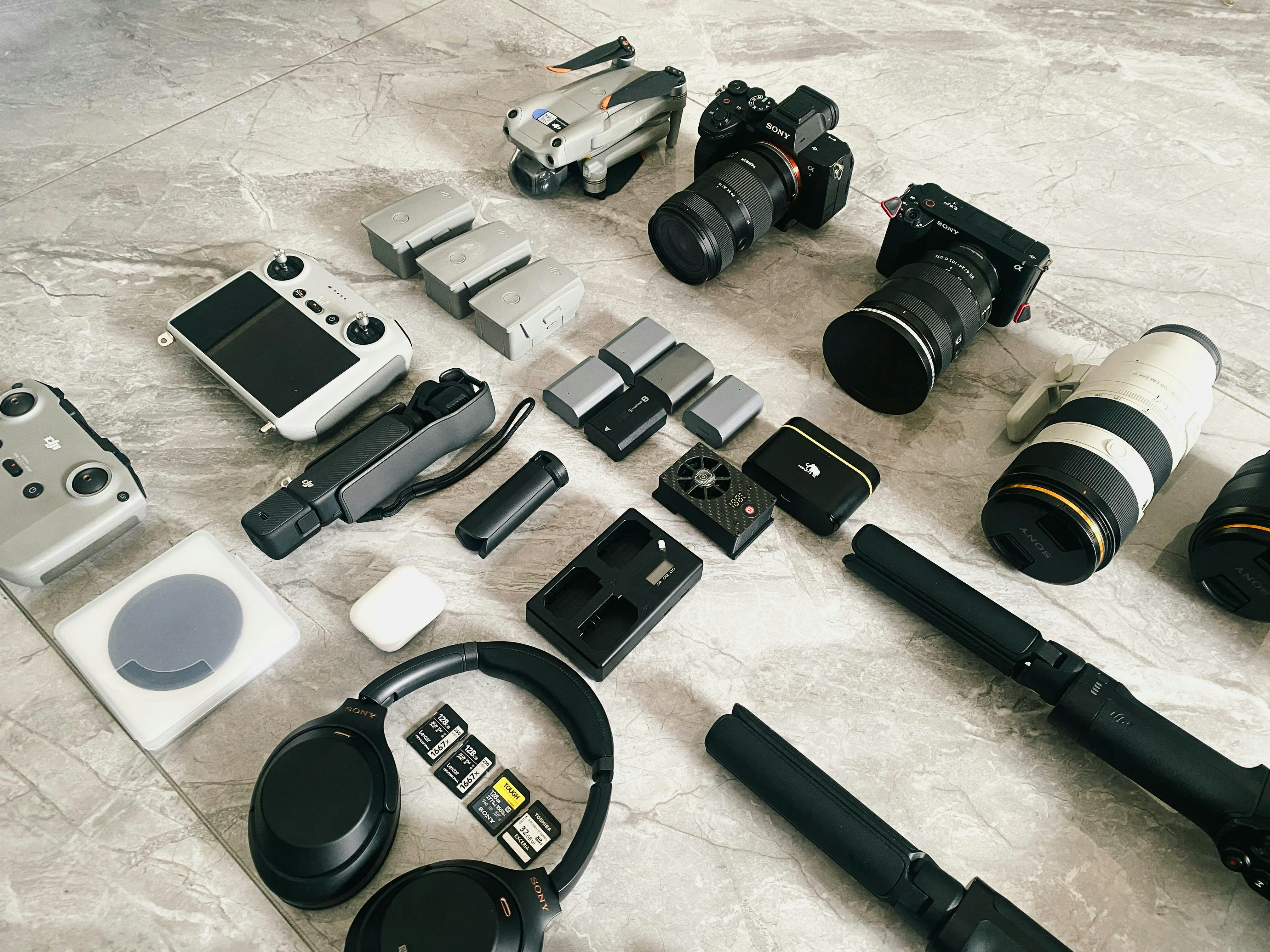 Various electronic gadgets and camera accessories laid out.