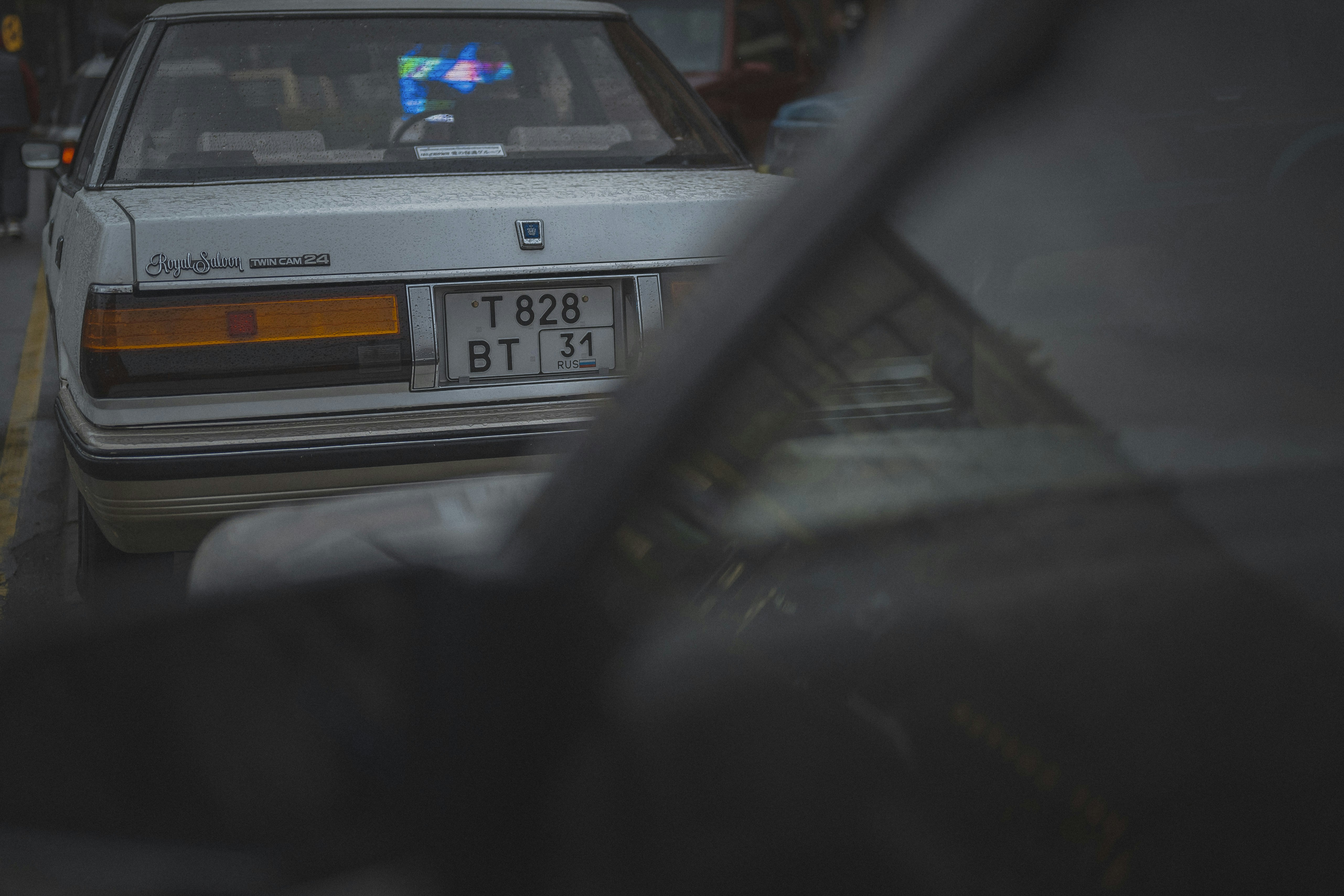 White car with license plate bt 31 in traffic