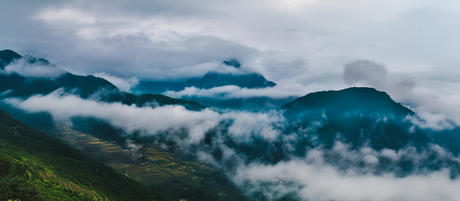 Misty mountains with clouds swirling around peaks
