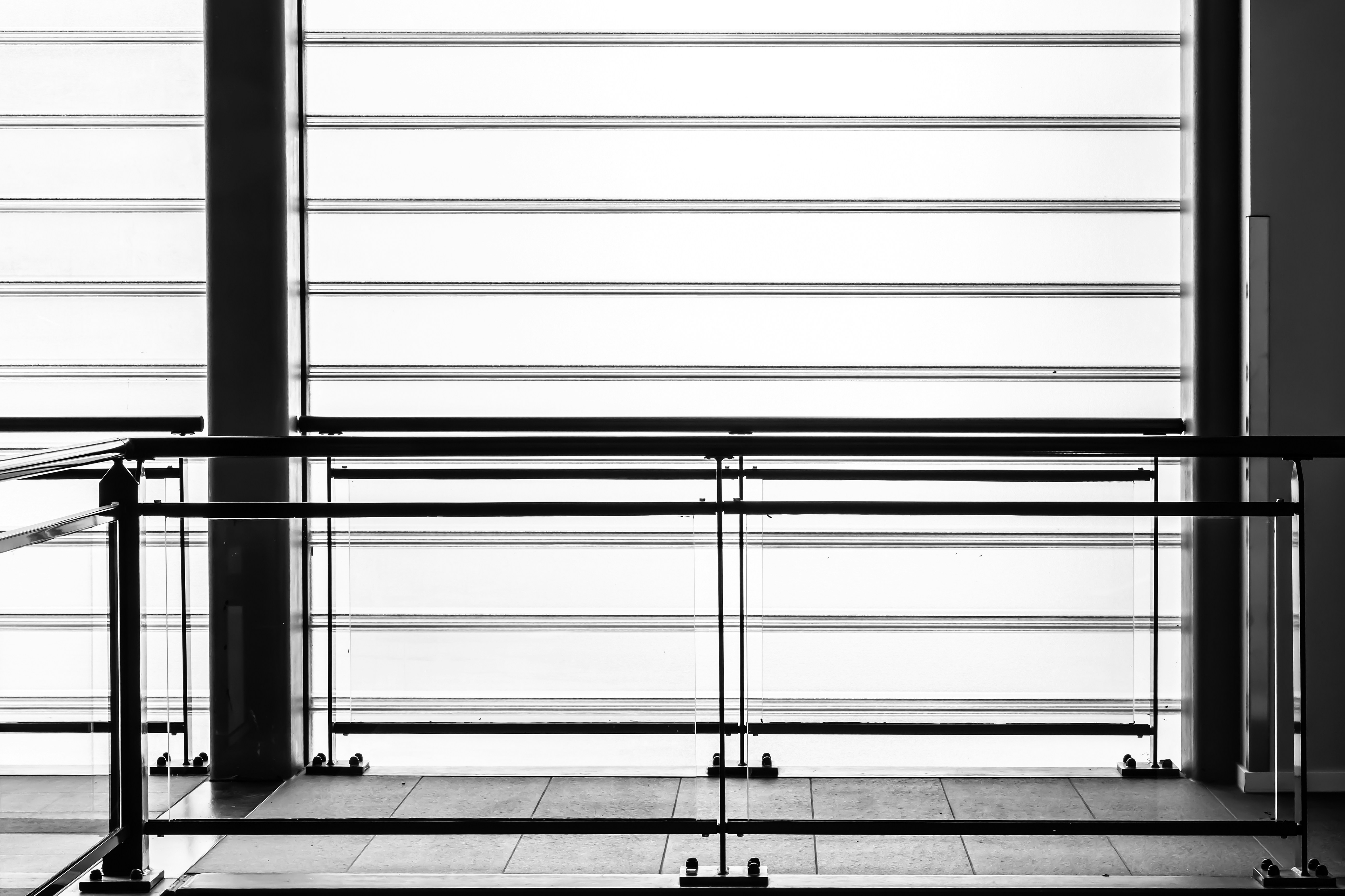 Modern interior with horizontal blinds and railing