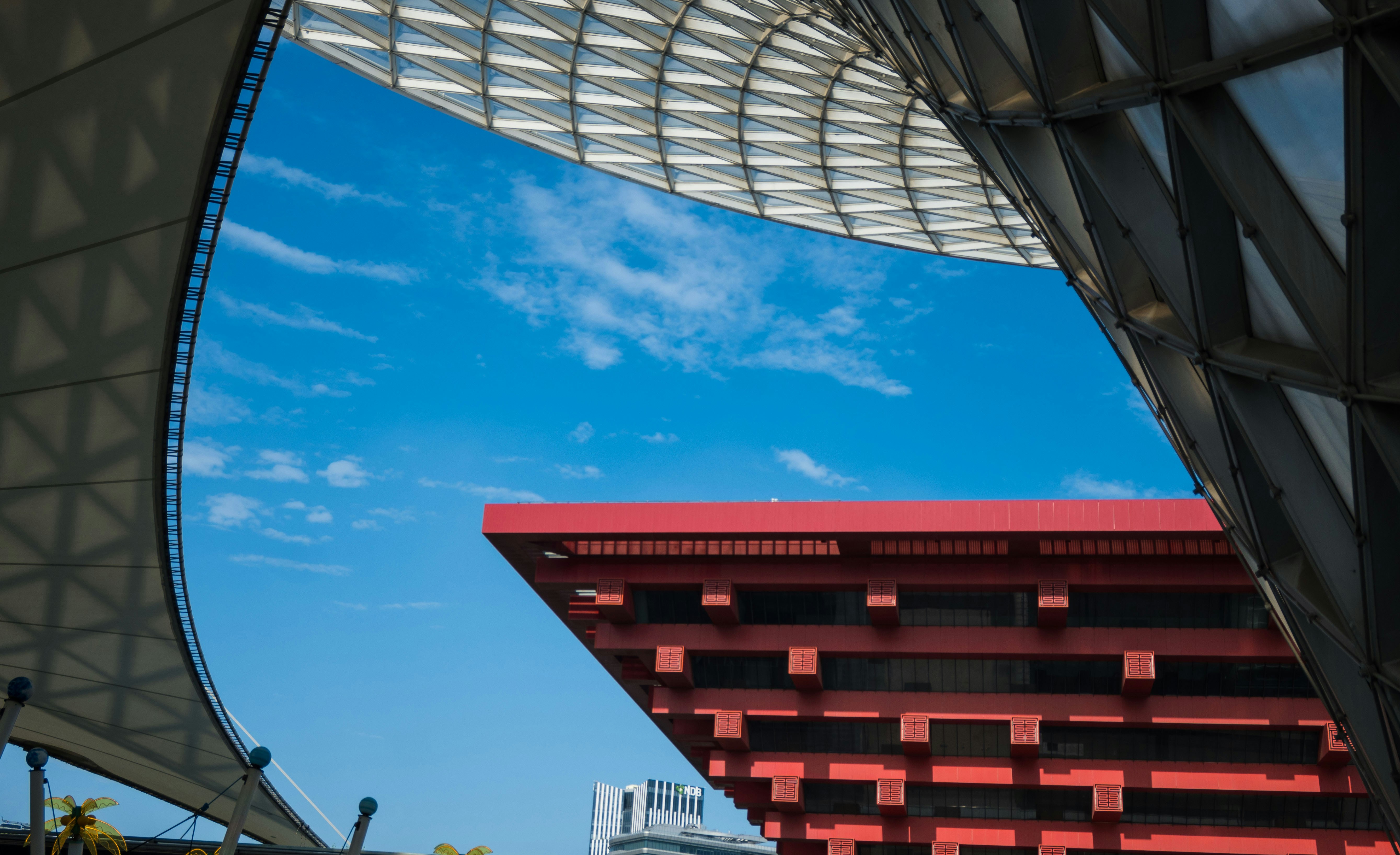 Modern architecture with red building against blue sky