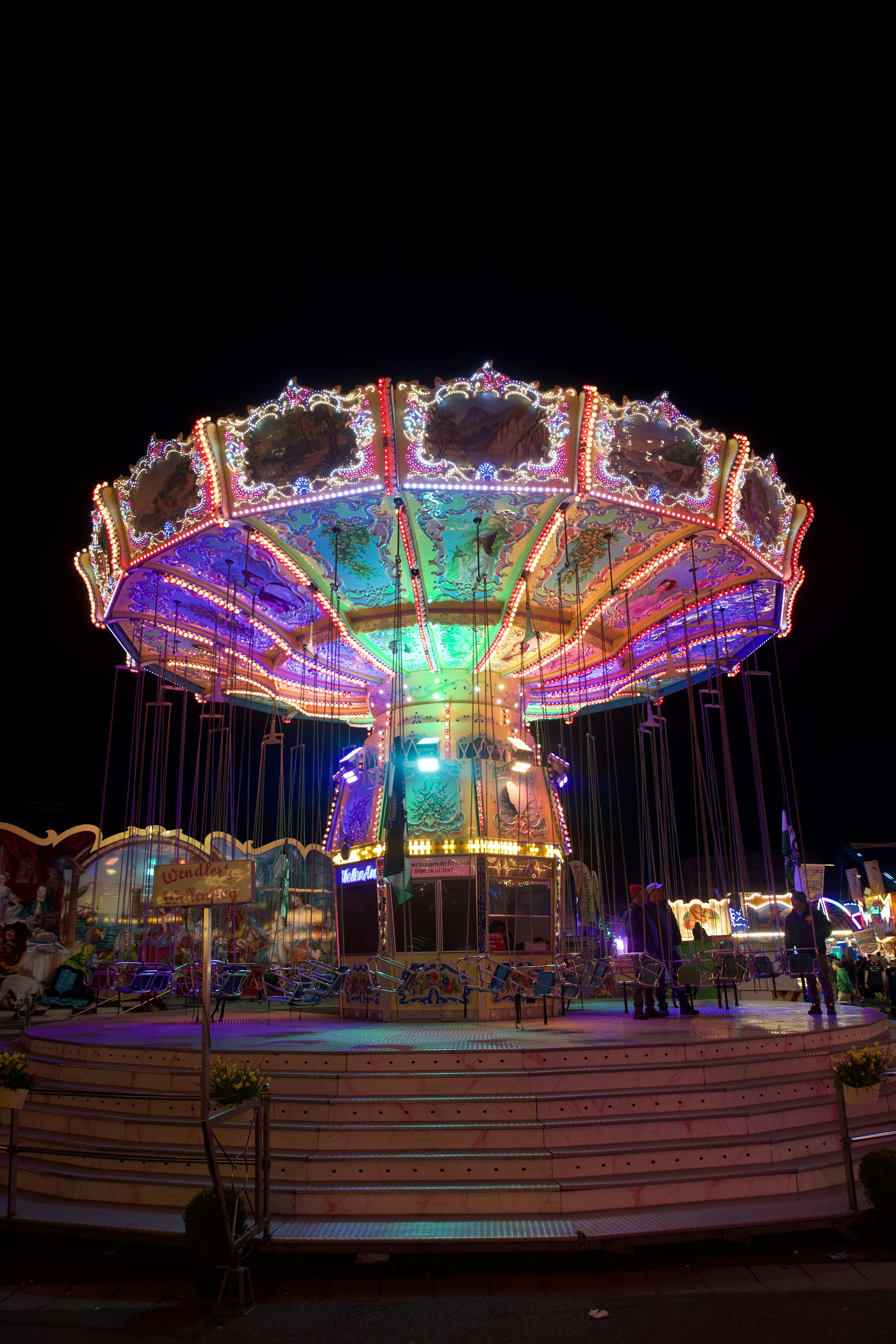 Colorful carnival swing ride illuminated at night photo – Free Night ...