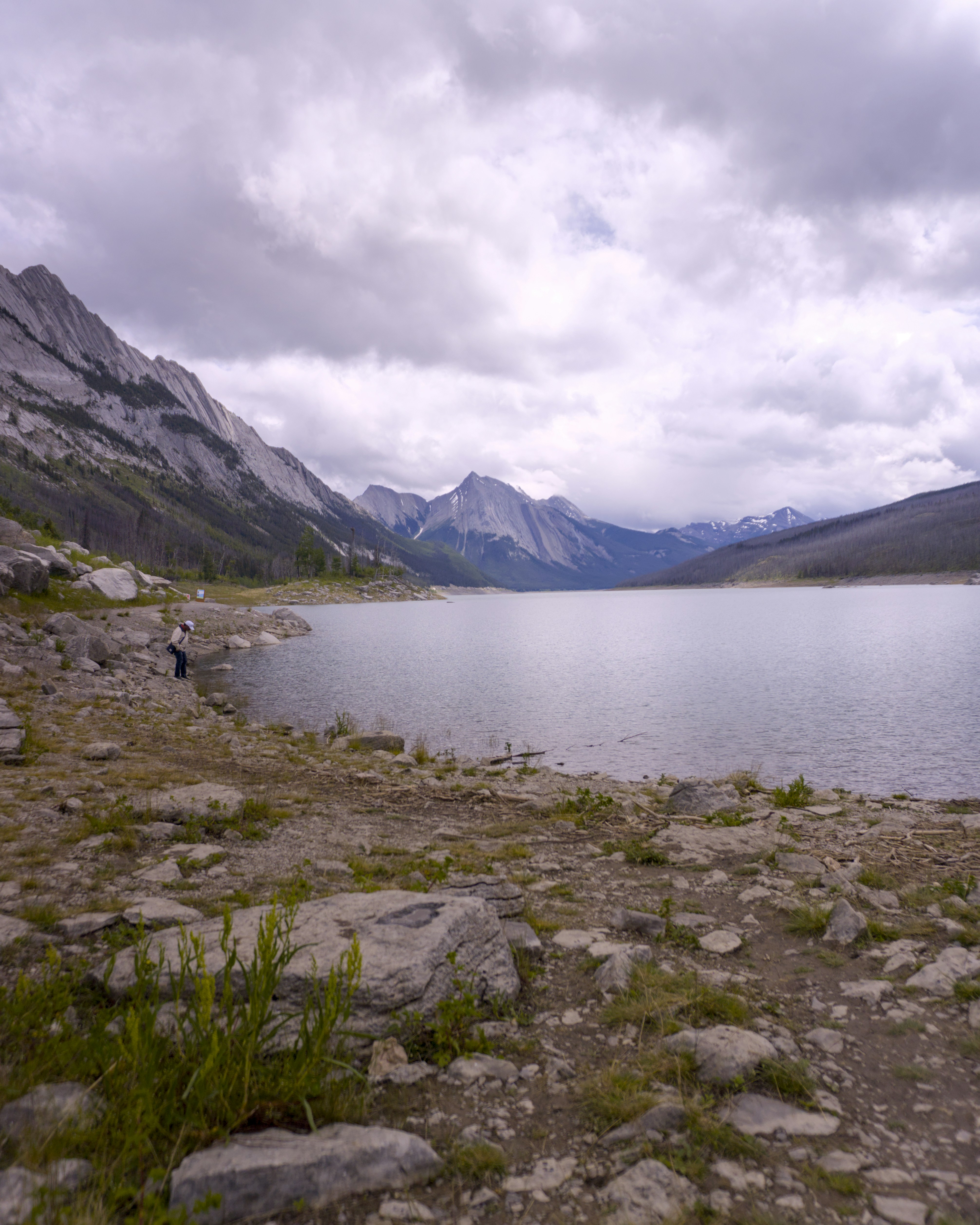 Rocky shore with mountains and a calm lake