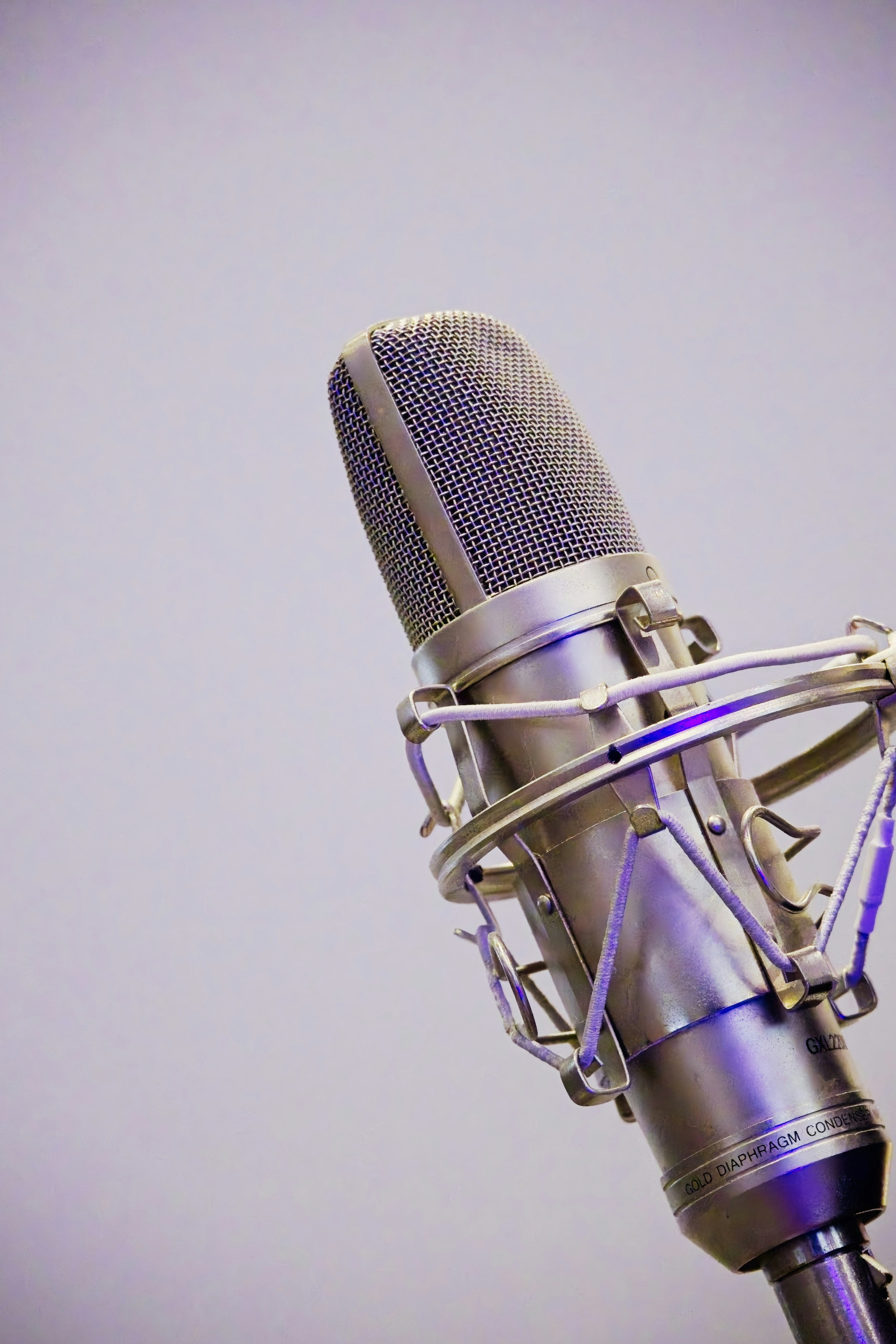 A silver studio microphone on a stand.